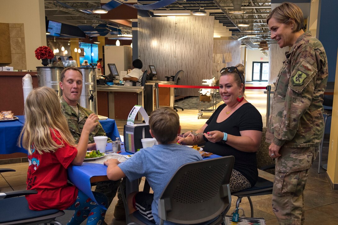 Col. Jennifer Short, 23d Wing commander, visits with participant during a deployed spouse dinner, May 21, 2019, at Moody Air Force Base, Ga. The dinner served as an opportunity for the families of deployed members to bond and provide relief. The mission’s success depends on resilient Airmen and families, who are prepared to make sacrifices with the support of their fellow Airmen, local communities and leadership. (U.S. Air Force photo by Airman 1st Class Taryn Butler)