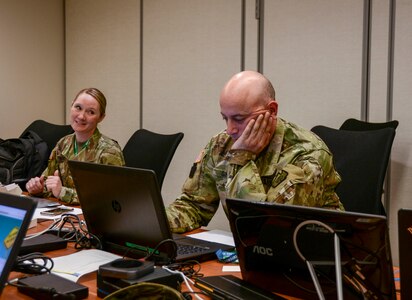 Maj. Christine Pierce, left,  Pennsylvania cyber branch chief, works with branch senior noncommissioned officer Sgt. 1st Class Elefterios E. Ginnis May 21 at the Pennsylvania Emergency Management Agency (PEMA) to ensure the integrity and security of the commonwealth’s primary elections.
