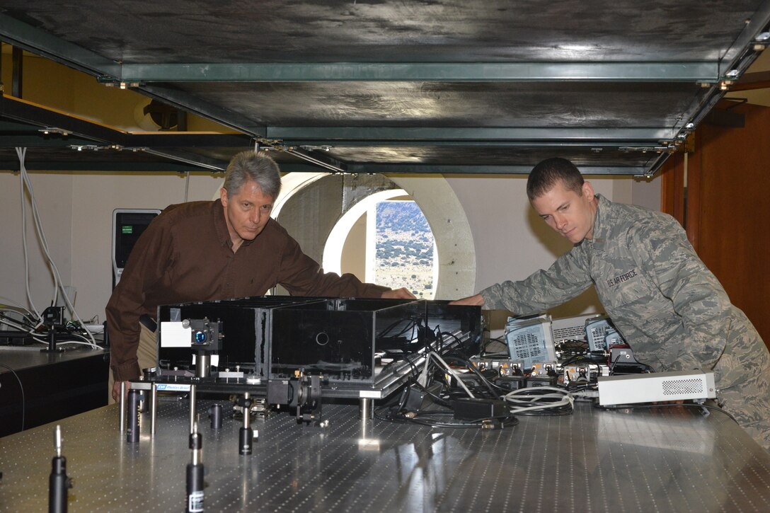 Air Force Research Laboratory researchers Dr. Mark Gruneisen and 2nd Lt. Eddie Hilburn make adjustments to the quantum key distribution testbed at the Starfire Optical range propagation site. (U.S. Air Force photo/Todd Berenger)