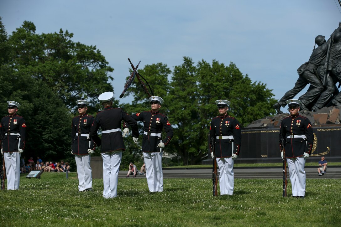 Marines with the U.S. Marine Corps Silent Drill Platoon, Marine Barracks Washington D.C., perform their “rifle inspection” sequence for an Honor Flight at the Marine Corps War Memorial, Arlington, Virginia, May 22, 2019. An Honor Flight is conducted by non-profit organizations dedicated to transporting as many United States military veterans as possible to see the memorials in D.C. of the respective war they fought in at no cost to the veterans. (U.S. Marine Corps photo by Pfc. Allen Sanders)