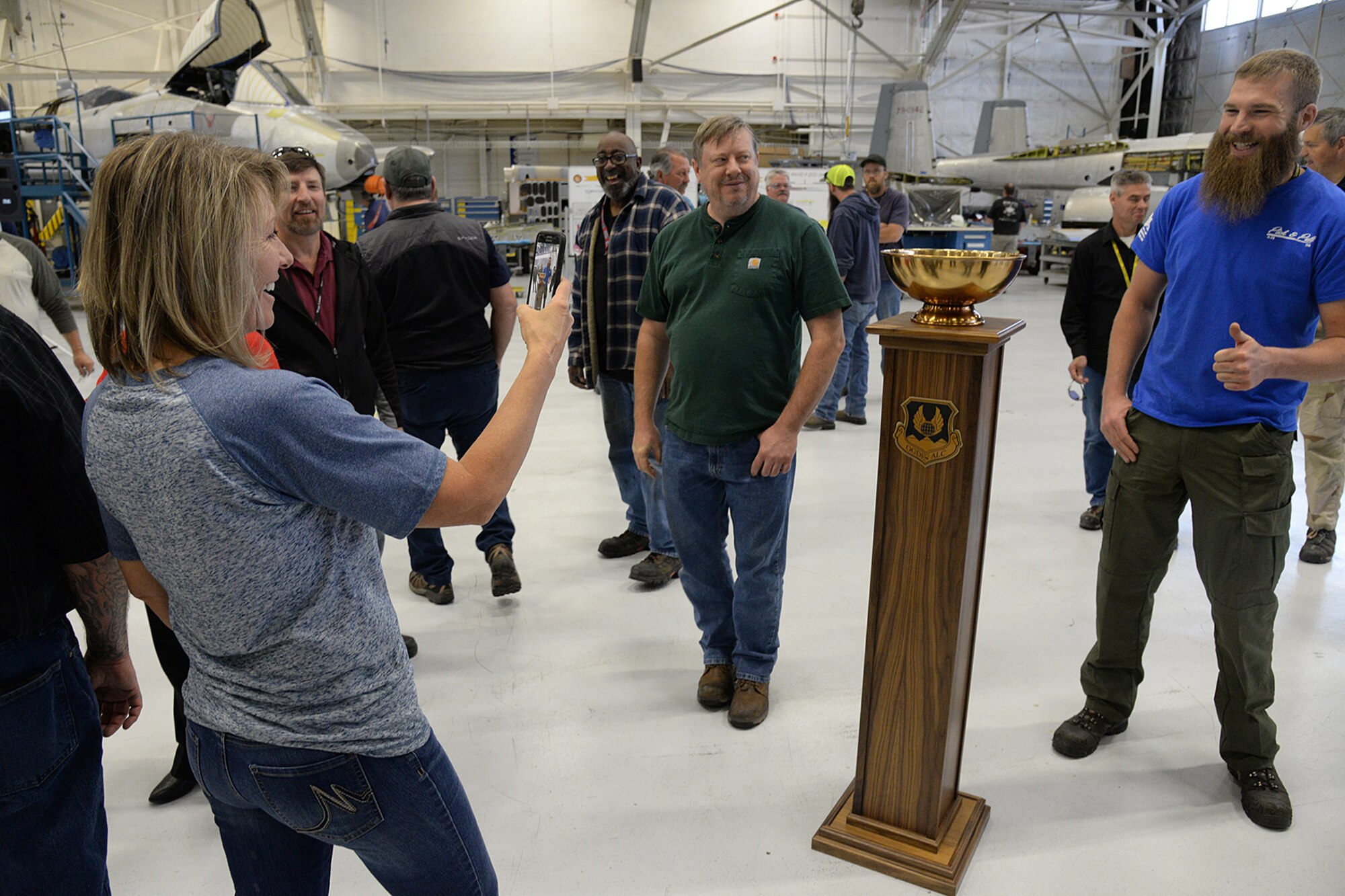 571st Aircraft Maintenance Squadron members pose for photos with the L-A-M-P Award trophy on May 9, at Hill Air Force Base, Utah. The new award is a traveling trophy which will be presented each month to the Complex’s most outstanding unit.