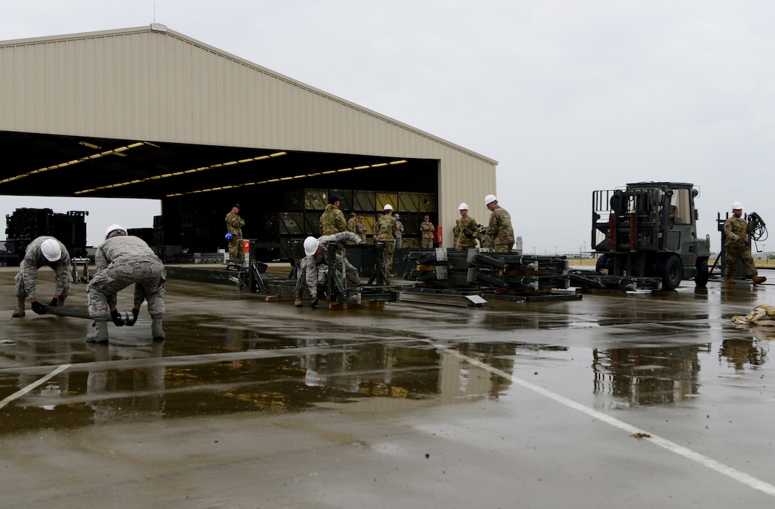 A team of Airmen from the 56th Equipment Maintenance Squadron build a munitions assembly conveyer during the Air Force Combat Operations Competition May 15, 2019, at Beale Air Force Base, California.