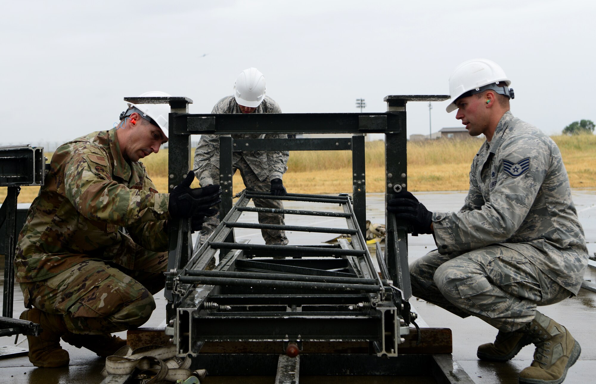 Airmen from the 56th Equipment Maintenance Squadron build a munitions assembly conveyer during the Air Force Combat Operations Competition May 15, 2019, at Beale Air Force Base, California.