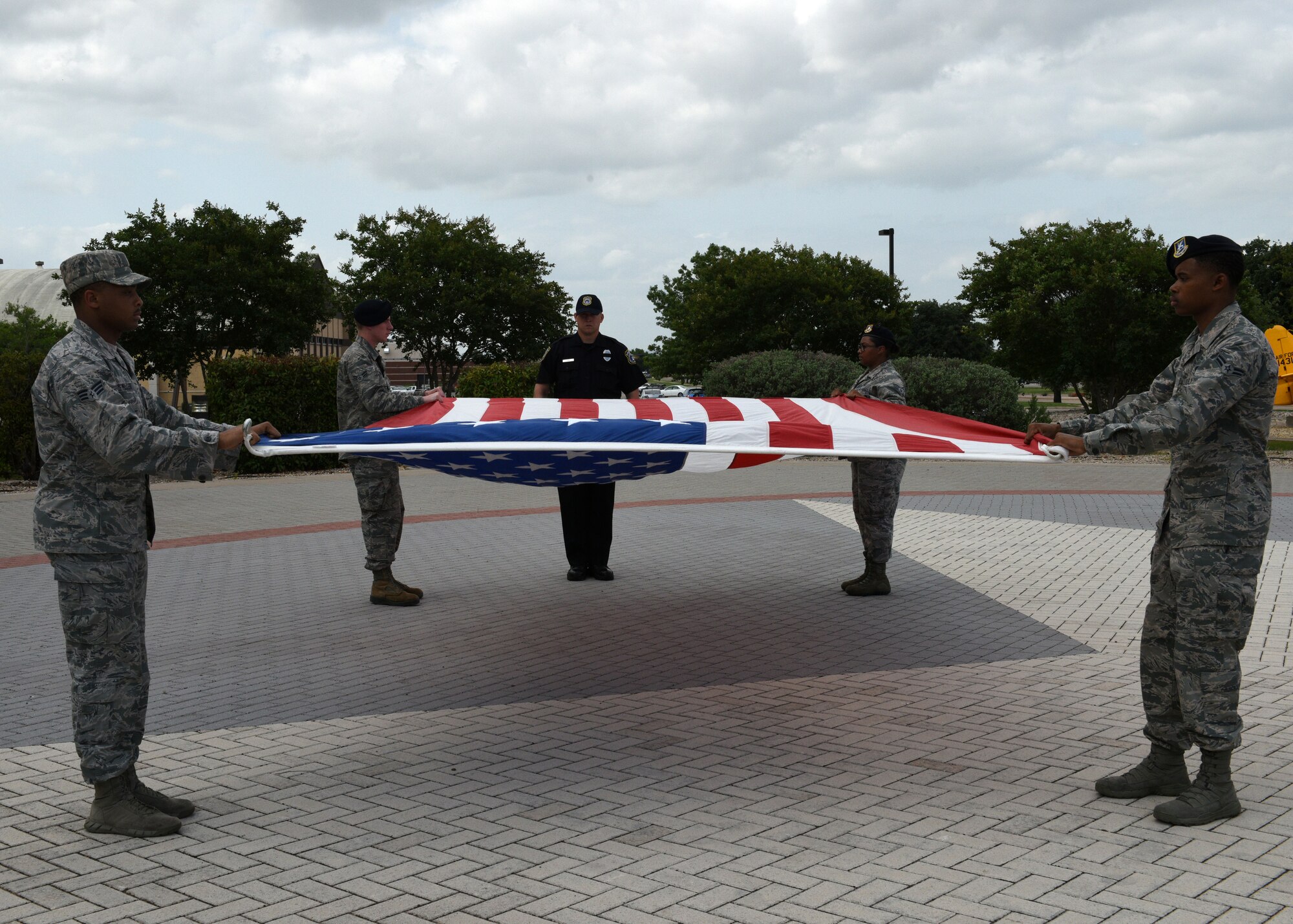 Members from the U.S. Air Force 17th Security Forces Squadron prepare to fold the flag during the special Retreat Ceremony signifying the end of Police Week on Goodfellow Air Force Base, Texas, May 17, 2019. Police week is an opportunity to express gratitude for the men and women who serve in law enforcement and those who have given their lives in service. (U.S. Air Force photo by Airman 1st Class Robyn Hunsinger/released)