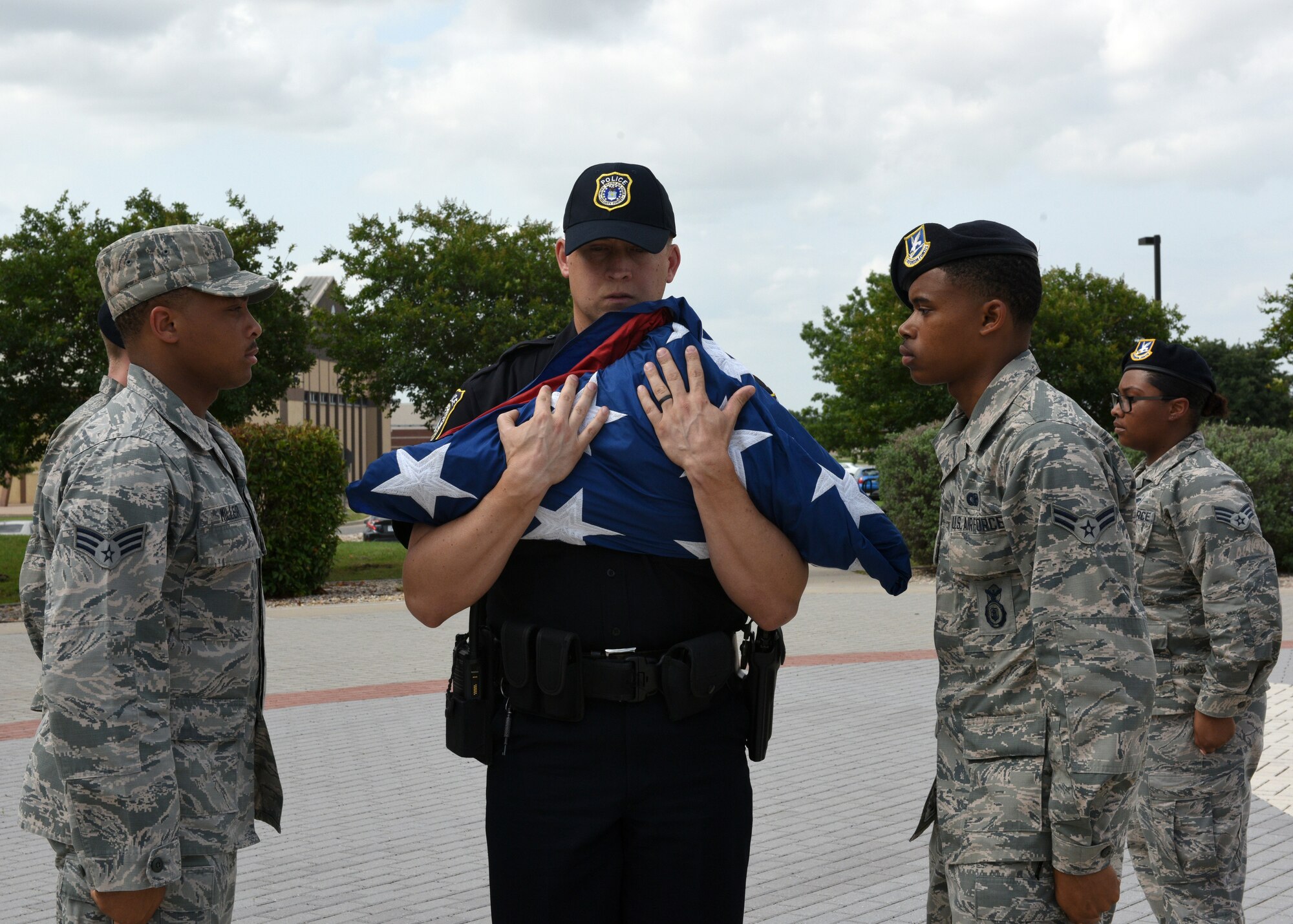 Members of the U.S. Air Force 17th Security Forces Squadron fold the flag during the special Retreat Ceremony signifying the end of Police Week on Goodfellow Air Force Base, Texas, May 17, 2019. Police Week is observed every year to honor police officers past and present. (U.S. Air Force photo by Airman 1st Class Robyn Hunsinger/released)