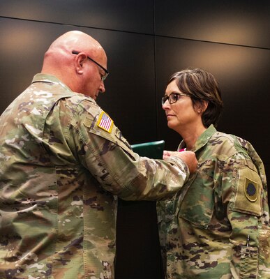 Maj. Gen. Michael Zerbonia, Assistant Adjutant General – Army and Commander, Illinois Army National Guard, presents Sgt. Maj. Sharon Hultquist, of Delavan, Illinois, with the Legion of Merit and the Illinois Distinguished Service Medal during her retirement ceremony May 17 at the Illinois Military Academy, Camp Lincoln, Springfield, Illinois. Hultquist retires May 31 after more than 30 years serving in the military. (U.S. Army photo by Barbara Wilson, Illinois National Guard Public Affairs Office)