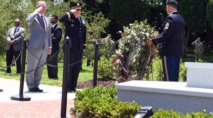 Louisiana Gov. John Bel Edwards and Maj. Gen. Glenn H. Curtis, adjutant general of the Louisiana National Guard, render a salute as taps is played during a ceremony for a new monument honoring fallen Louisiana Guardsmen at Louisiana Veterans Memorial Park in Baton Rouge on May 21, 2019.