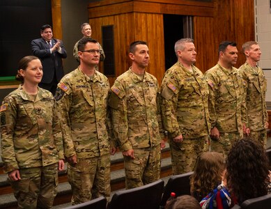 Soldiers from Detachment 5, Company A, 2nd Battalion, 245th Aviation Regiment, stand to be recognized during the mobilization ceremony May 22 at Camp Lincoln, Springfield, Illinois. The unit will deploy to the Horn of Africa. (U.S. Army photo by Barbara Wilson, Illinois National Guard Public Affairs Office.)