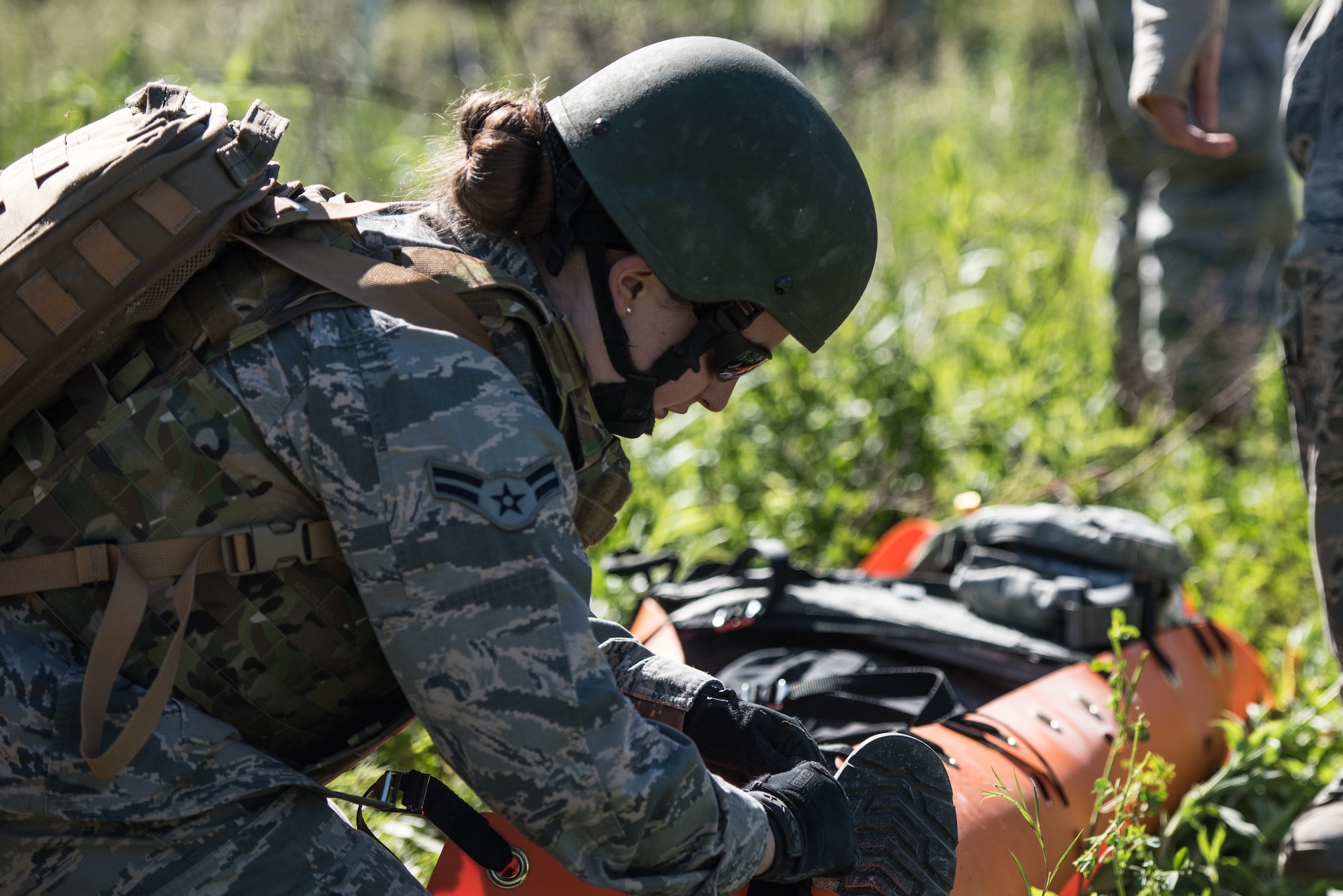 U.S. Air Force Airman 1st Class Kayla Rhodes, a medic with the 193rd Special Operations Medical Group Detachment 1, Pennsylvania Air National Guard, secures a casualty on a litter during Tactical Combat Casualty Care training.