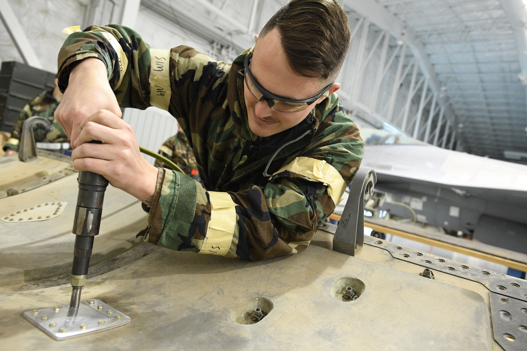 Avionics technician Staff Sgt. Lance Mosley, 309th Aircraft Maintenance Group Expeditionary Depot Maintnenance, installs a sheet metal repair during an exercise at Hill Air Force Base, Utah, May 21, 2019.