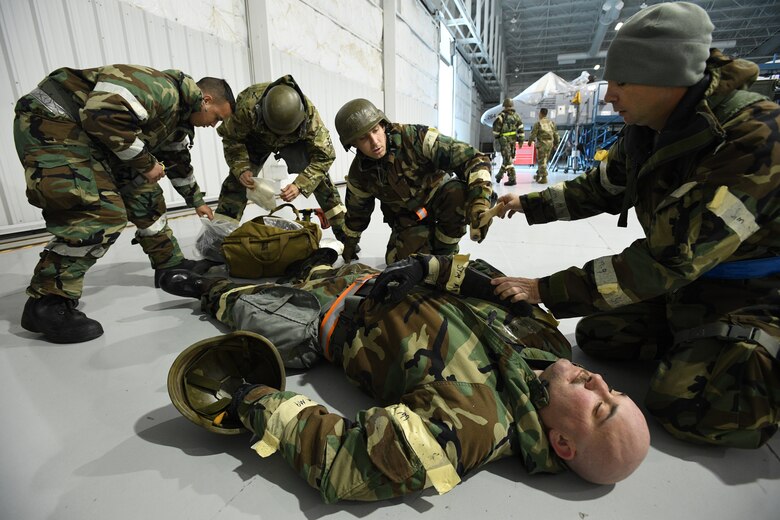 Airmen assigned to 309th Aircraft Maintenance Group Expeditionary Depot Maintenance assess a simulated casualty during an exercise at Hill Air Force Base, Utah, May 21, 2019.