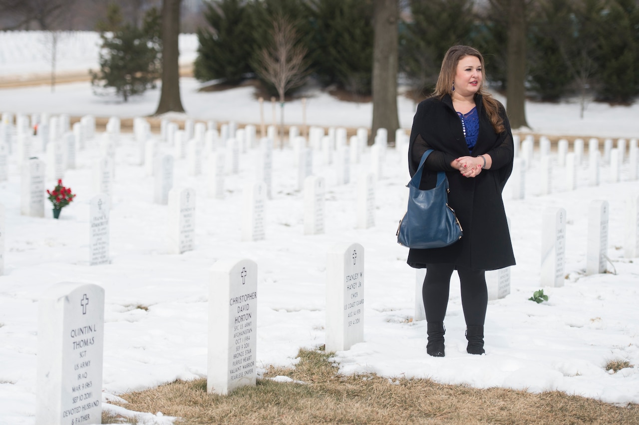 A woman walks in graveyard.