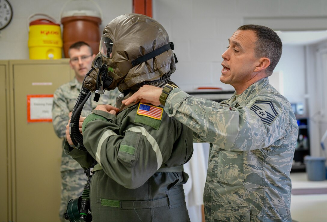 Senior Master Sgt. Jim Haupt, superintendent of aircrew flight equipment assigned to the 910th Operations Support Squadron, checks the fitting of an aircrew eye respiratory protection system of Master Sgt. Rich Lawton, an instructor flight engineer assigned to the 757th Airlift Squadron on May 4, 2019.
