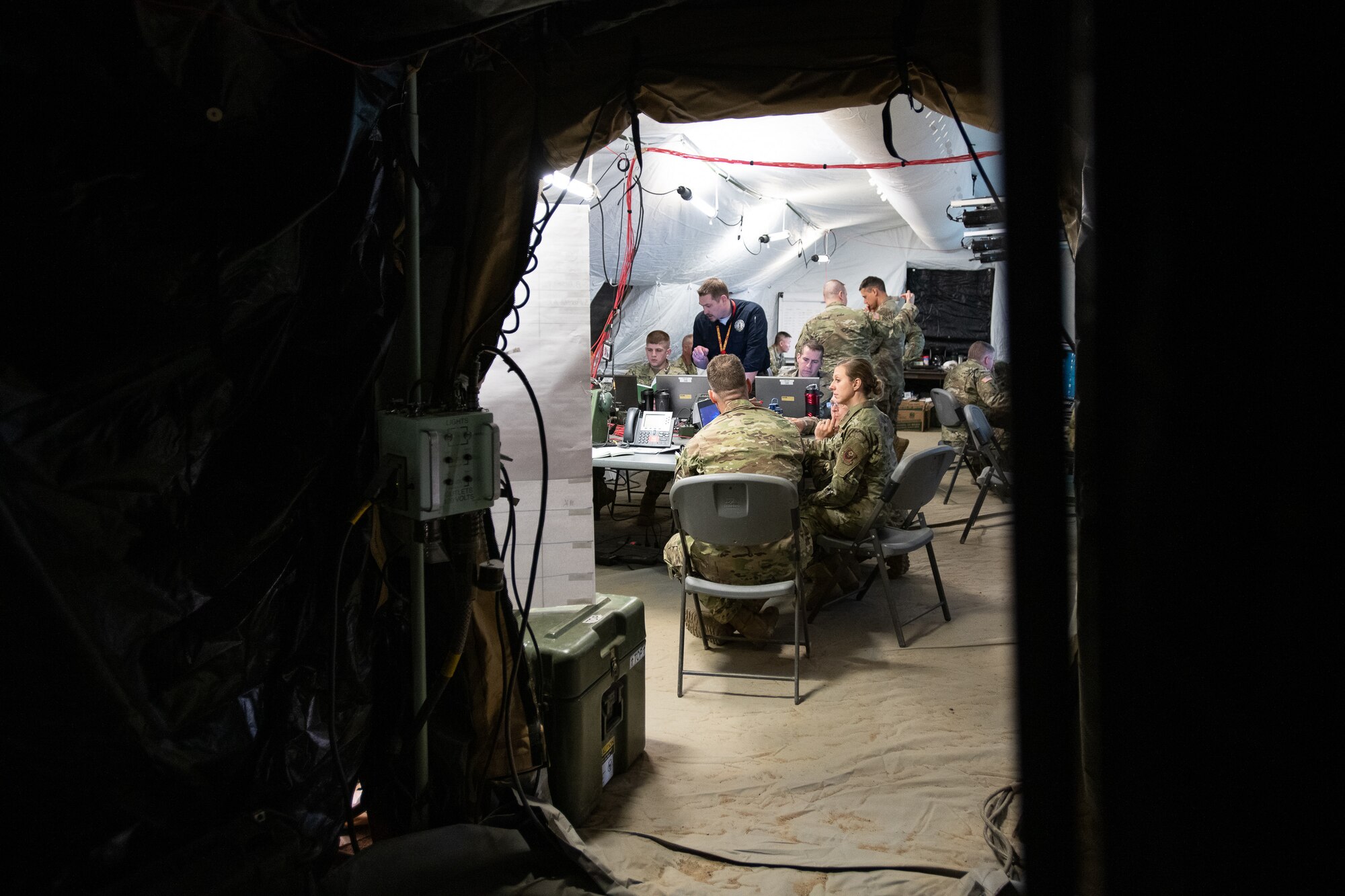 Oklahoma Air National Guardsmen, Staff Sgt. Jeremy Long (left) and Tech. Sgt. Timothy Davis, brigade tactical air control party team sergeants assigned to the 146th Air Support Operations Squadron (146th ASOS), and Capt. Cristi Campbell, 285th Special Operations Intelligence Squadron intelligence analyst work to establish network communications with fellow exercise participants in the tactical operation center at a Warfighter exercise (WFX 19-12) held at Camp Ripley near Little Falls, Minn., May 12, 2019. The 24-hour continuous, graded exercise, which is the second of three exercises that U.S. Army and National Guard units are required to complete before deployment, tests the units at the brigade level before heading to the final and more applied exercise at the National Training Center (NTC), in Fort Irwin, Calif. (U.S. Air National Guard photo by Tech. Sgt. Kasey M. Phipps)