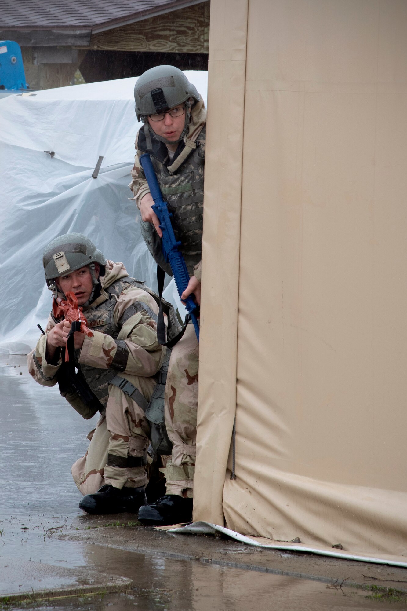 Airmen with the 319th Logistics Readiness Squadron take cover behind a wall in defense of a potential adversary attack May 22, 2019, during exercise Summer Viking 19-01 on the Air National Guard Base in Fargo, North Dakota. Responding to attacks and defending camp was part of the 4-day exercise which focused on increased readiness. (U.S. Air Force photo by Senior Airman Elora J. Martinez)