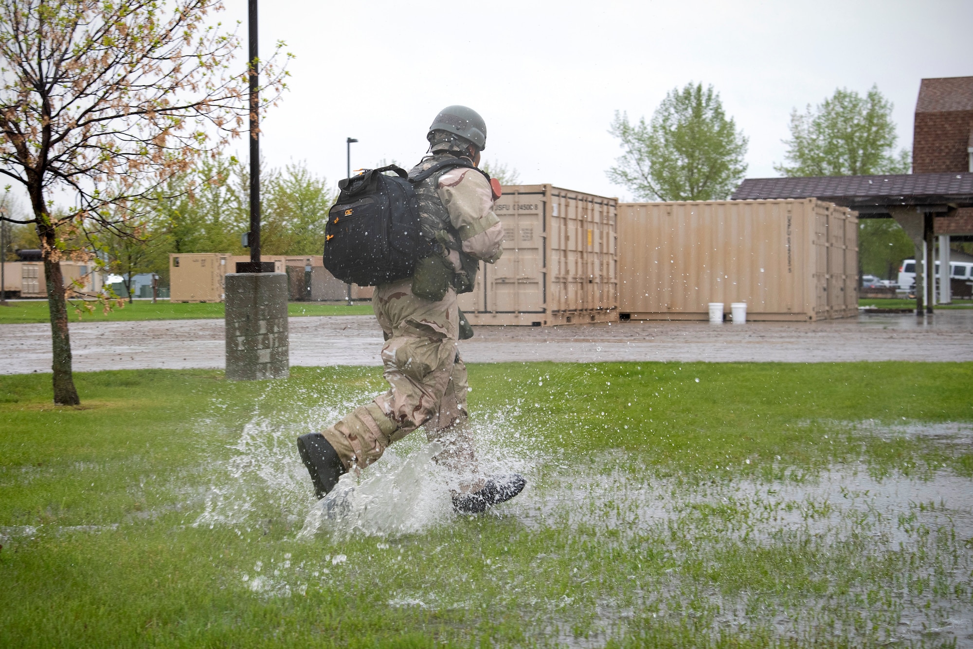 A Grand Forks Air Force Base airman runs across a simulated deployment camp in response to an attack May 22, 2019, during exercise Summer Viking 19-01 on the Air National Guard Base in Fargo, North Dakota. The 4-day exercise tested participants’ organizational, expeditionary and readiness skills to better prepare for real deployment. (U.S. Air Force photo by Senior Airman Elora J. Martinez)