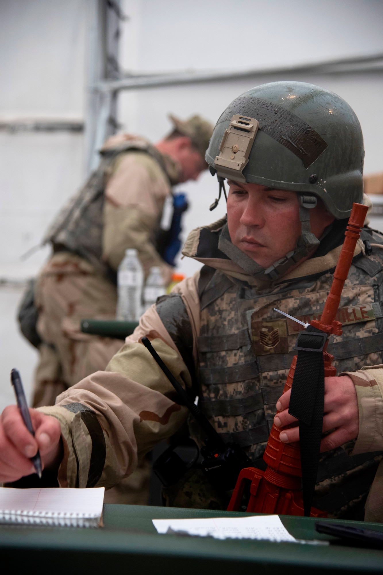 Tech. Sgt. Jason Jumonville, 319th logistics Readiness Squadron fuels operations section chief, notes the names of injured airmen following a simulated attack May 22, 2019, during exercise Summer Viking 19-01 on the Air National Guard Base in Fargo, North Dakota. The 4-day exercise consisted of deploying Grand Forks Air Force Base airmen to a forward operating base, setting up a temporary camp and responding to threats of chemical and biological contamination or adversaries. (U.S. Air Force photo by Senior Airman Elora J. Martinez)