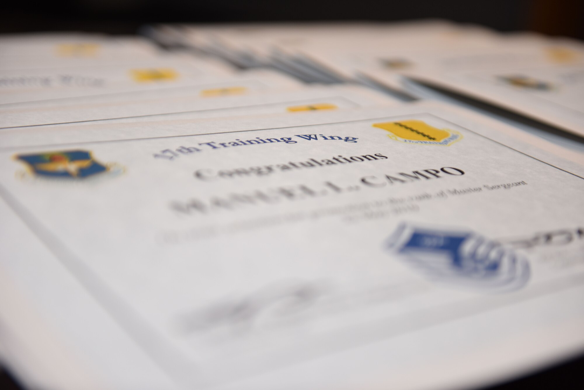Certificates for Goodfellow’s newest master sergeant selects wait to be presented during the Master Sergeant select ceremony at the event center on Goodfellow Air Force Base, Texas, May 23, 2019. Master sergeants transition from being technical experts and first line supervisors to leaders of operational competence skilled at merging subordinates’ talents, skills, and resources to most effectively accomplish the mission. (U.S. Air Force photo by Senior Airman Seraiah Hines/Released