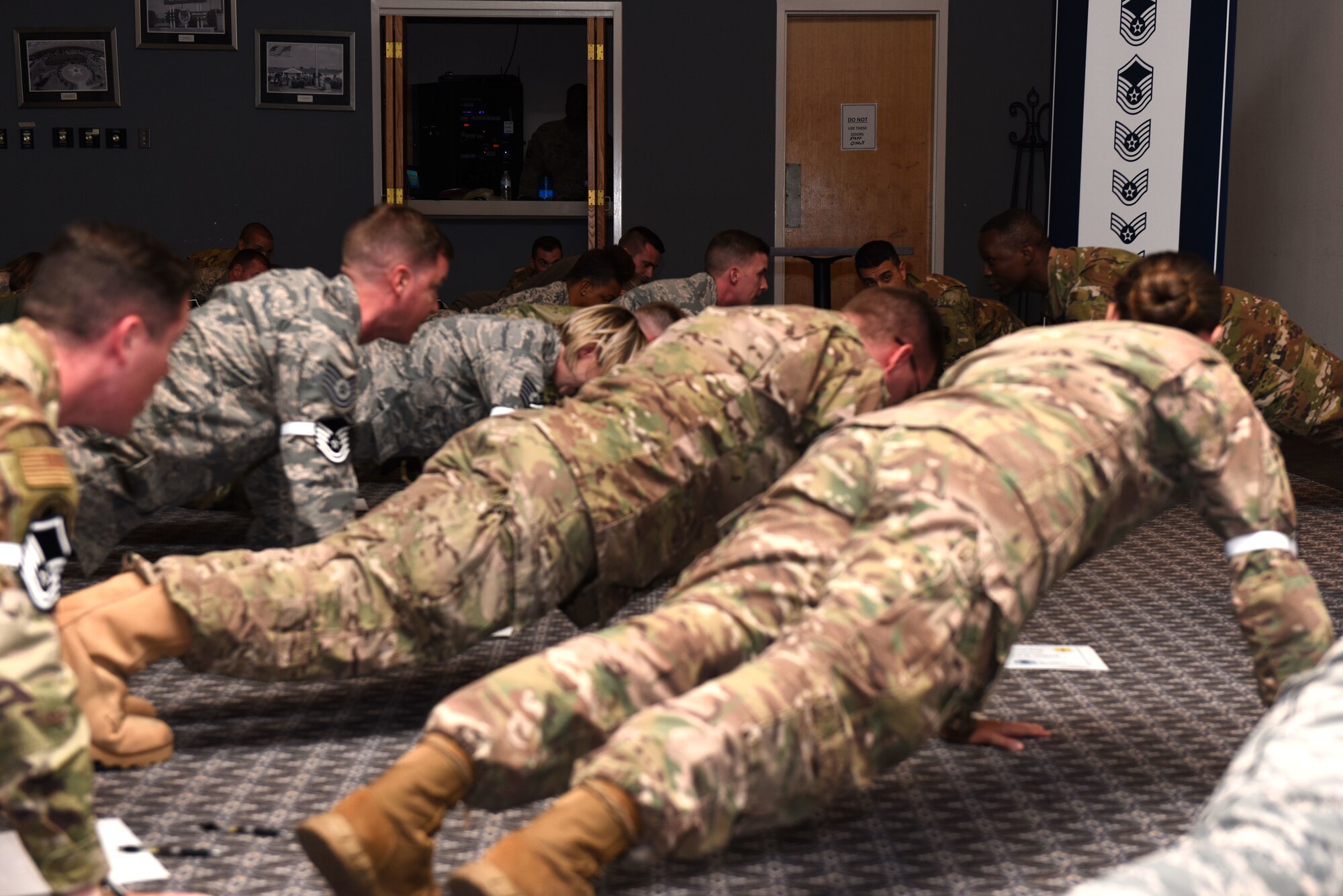 The newest selects into the noncommissioned tier of the Air Force take a moment to do 17 pushups to celebrate with leadership at the Master Sergeant Select Ceremony at the event center on Goodfellow Air Force Base, Texas, May 23, 2019. Master sergeants continue to develop their leadership and management skills through significantly increased responsibilities and requirement of a broad technical and managerial perspective. (U.S. Air Force photo by Senior Airman Seraiah Hines/Released)