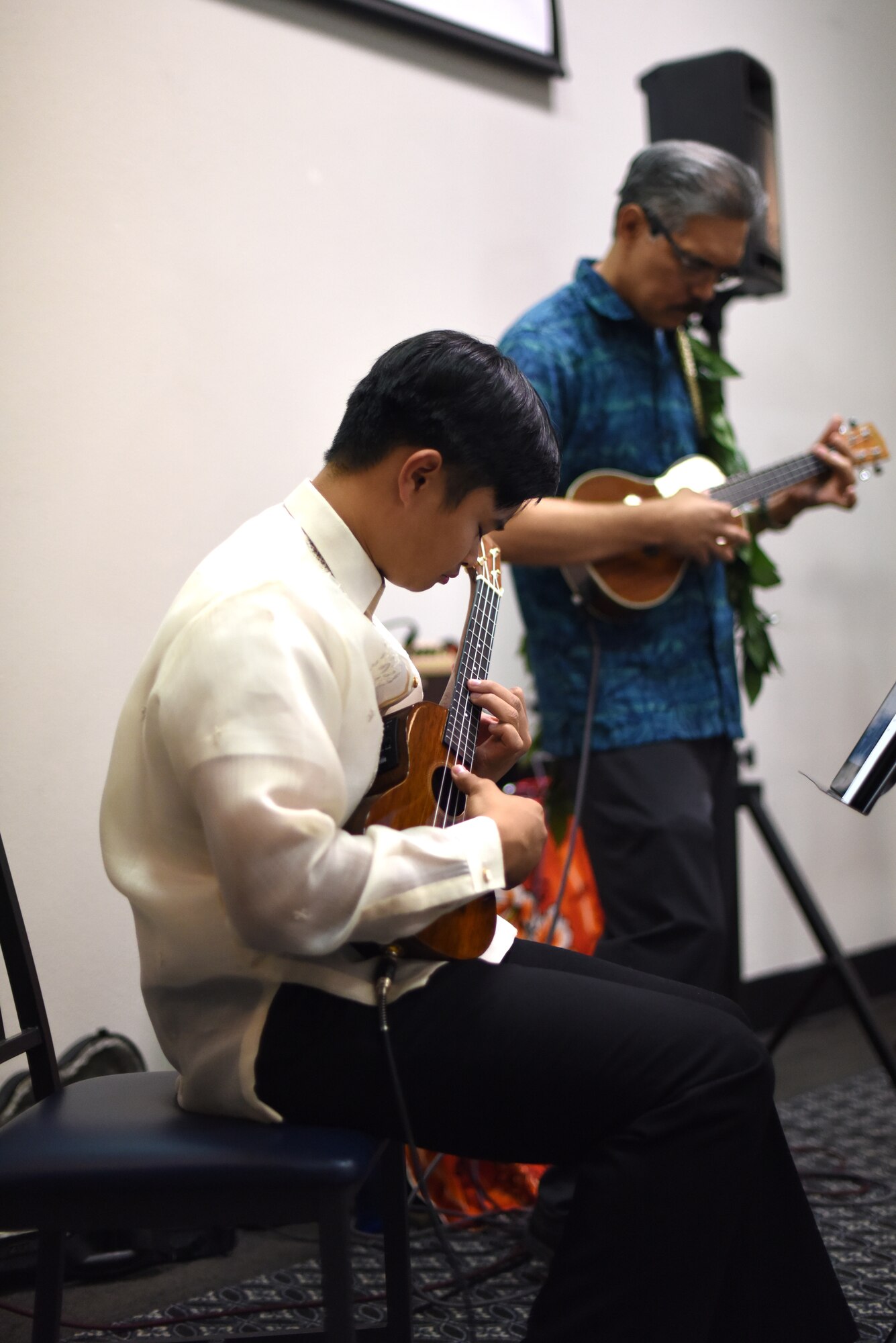 Abraham Salomon III and Joe Aquino, participants at the Asian American Pacific Islander Heritage Month Culture Event, perform multiple songs on the ukulele at the event center on Goodfellow Air Force Base, Texas, May 22, 2019. During the performance individuals performed different Samoan dances. (U.S. Air Force photo by Senior Airman Seraiah Hines/Released)