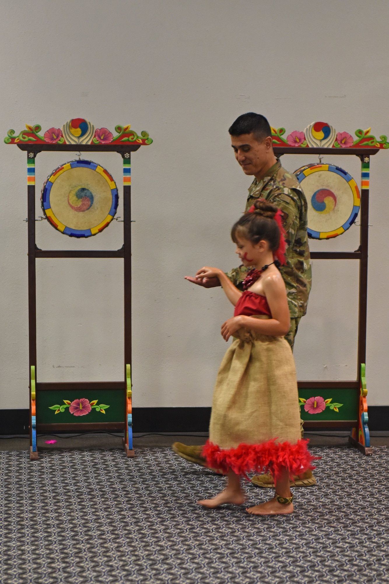 U.S. Air Force Col. Ricky Mills, 17th Training Wing commander, leads his daughter onto the dance floor to perform the Samoan dance called the “Taualuga” which symbolizes the conclusion of a monumental task and the beautifying final touches involved during the Asian American Pacific Islander Heritage Month Culture Event at the event center on Goodfellow Air Force Base, Texas, May 22, 2019. This dance is sacred to the Samoan people and is performed by the son or daughter of a Chief. (U.S. Air Force photo by Senior Airman Seraiah Hines/Released)
