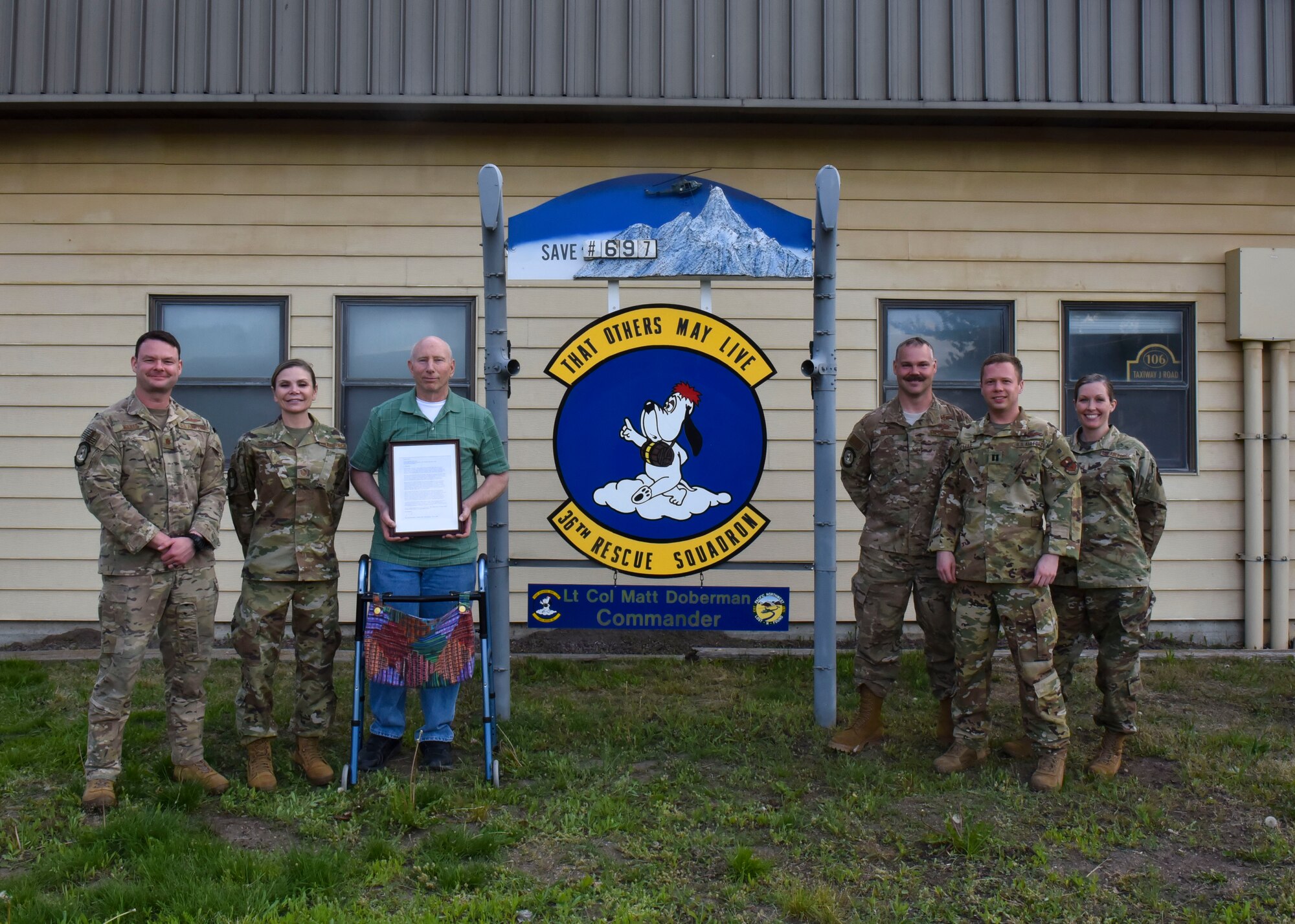 Karl Shoemaker and Airmen from the 36th Rescue Squadron and Survival, Evasion, Resistance and Escape, pose for a photo