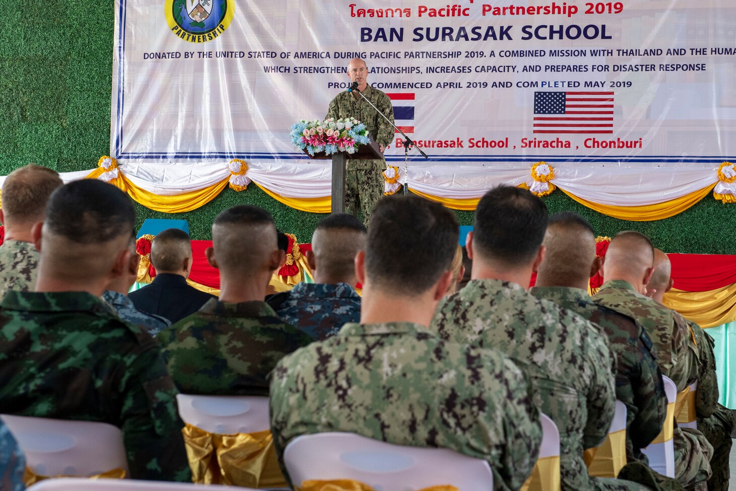 CHON BURI, Thailand (May 23, 2019) – U.S. Navy Capt. Randy Van Rossum, Pacific Partnership 2019 (PP19) mission commander, speaks at a ribbon cutting ceremony that marks the completion of a library, also designed to function as a shelter in the event of a natural disaster, constructed at Ban Surasak School by engineers from PP19 partner nations. Pacific Partnership, now in its 14th iteration, is the largest annual multinational humanitarian assistance and disaster relief preparedness mission conducted in the Indo-Pacific. Each year the mission team works collectively with host and partner nations to enhance regional interoperability and disaster response capabilities, increase security and stability in the region, and foster new and enduring friendships in the Indo-Pacific.