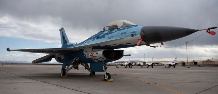 An F-16 Fighting Falcon fighter jet sits on the flight line.