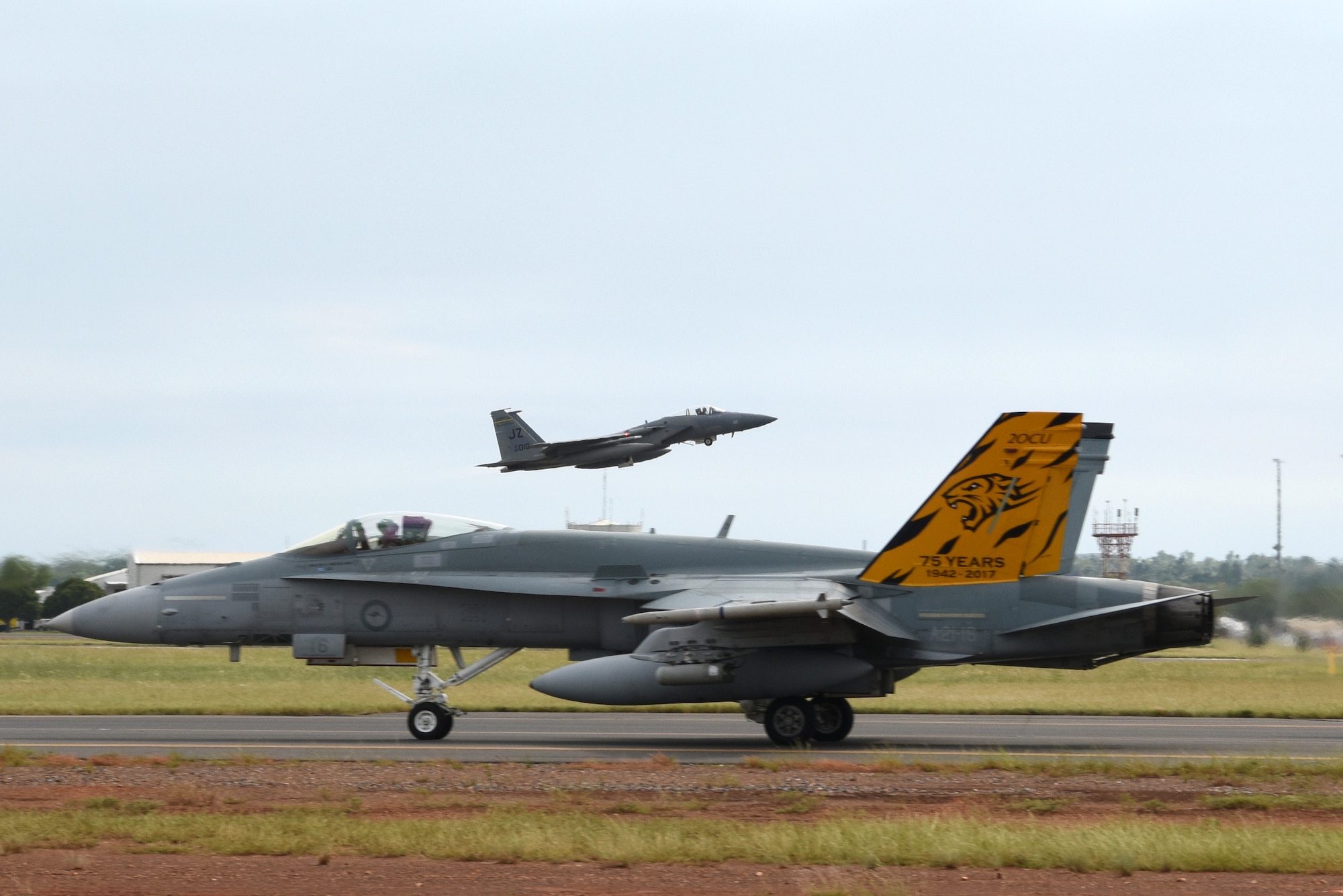 A U.S. Air Force F-15C Eagle assigned to the 194th Expeditionary Fighter Squadron, California Air National Guard, takes off while a Royal Australian Air Force F/A-18A Hornet taxis during Exercise Diamond Storm at RAAF Base Darwin, Northern Territory, May 10, 2019.
