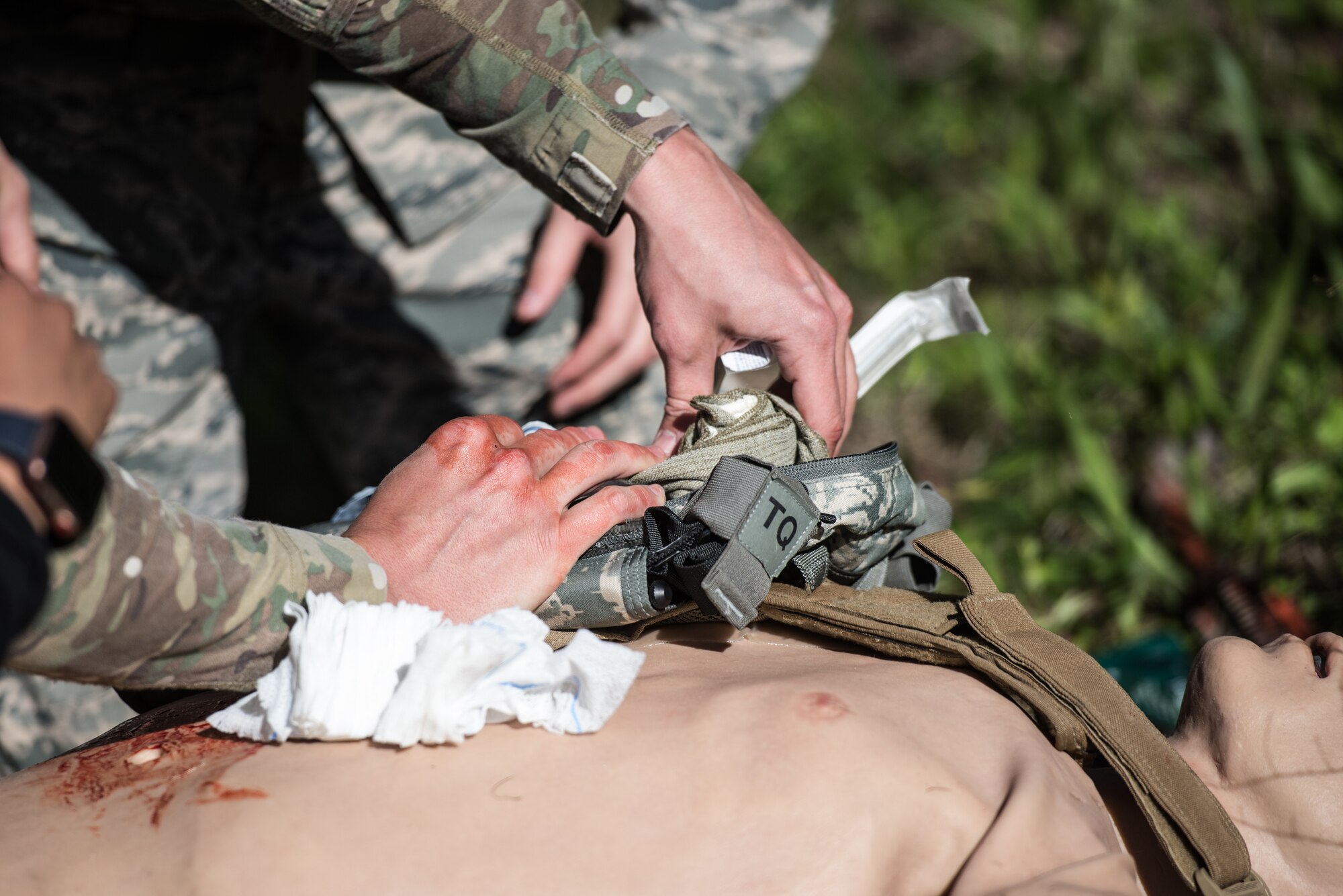 A U.S. Airman from the 193rd Special Operations Medical Group Detachment 1, Pennsylvania Air National Guard, performs medical treatment on a casualty during Tactical Combat Casualty Care training at Annville, Pennsylvania, May 21, 2019. The TCCC training focused on three phases of care: care under fire, tactical field care, and tactical evacuation care. (U.S. Air National Guard photo by Staff Sgt. Tony Harp)