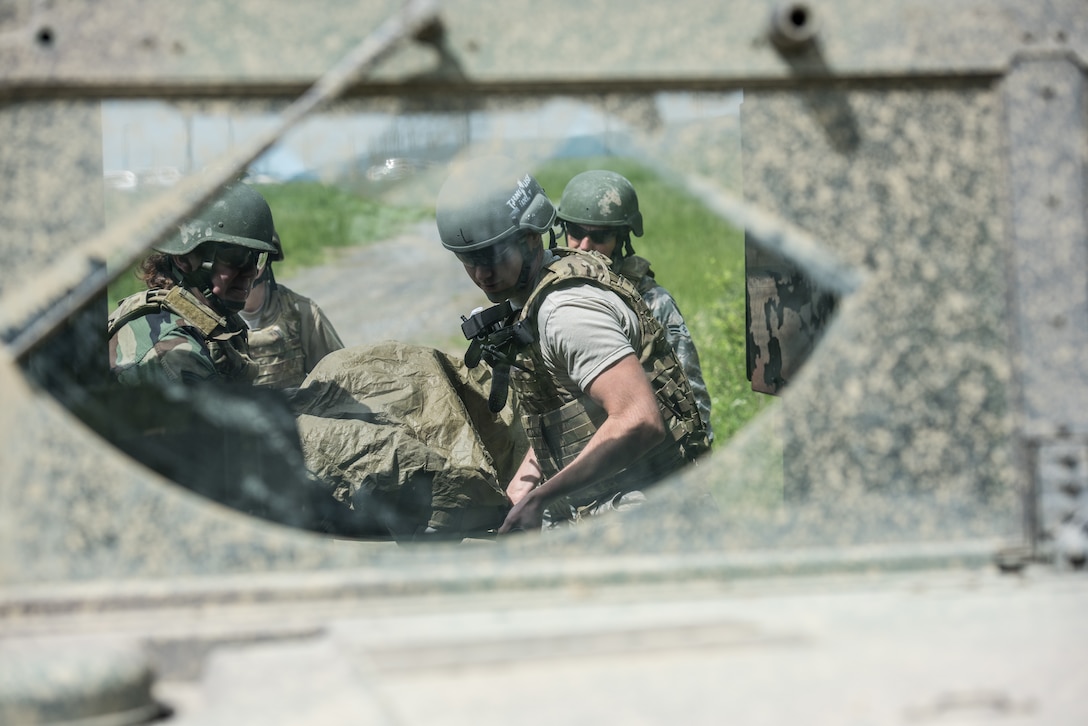U.S. Airmen from the 193rd Special Operations Medical Group Detachment 1, Pennsylvania Air National Guard, evacuate a casualty into the back of a Humvee during Tactical Combat Casualty Care training at Annville, Pennsylvania, May 21, 2019. The TCCC training provides Airmen with the fundamentals of treating and evacuating casualties in a combat environment. (U.S. Air National Guard photo by Staff Sgt. Tony Harp)