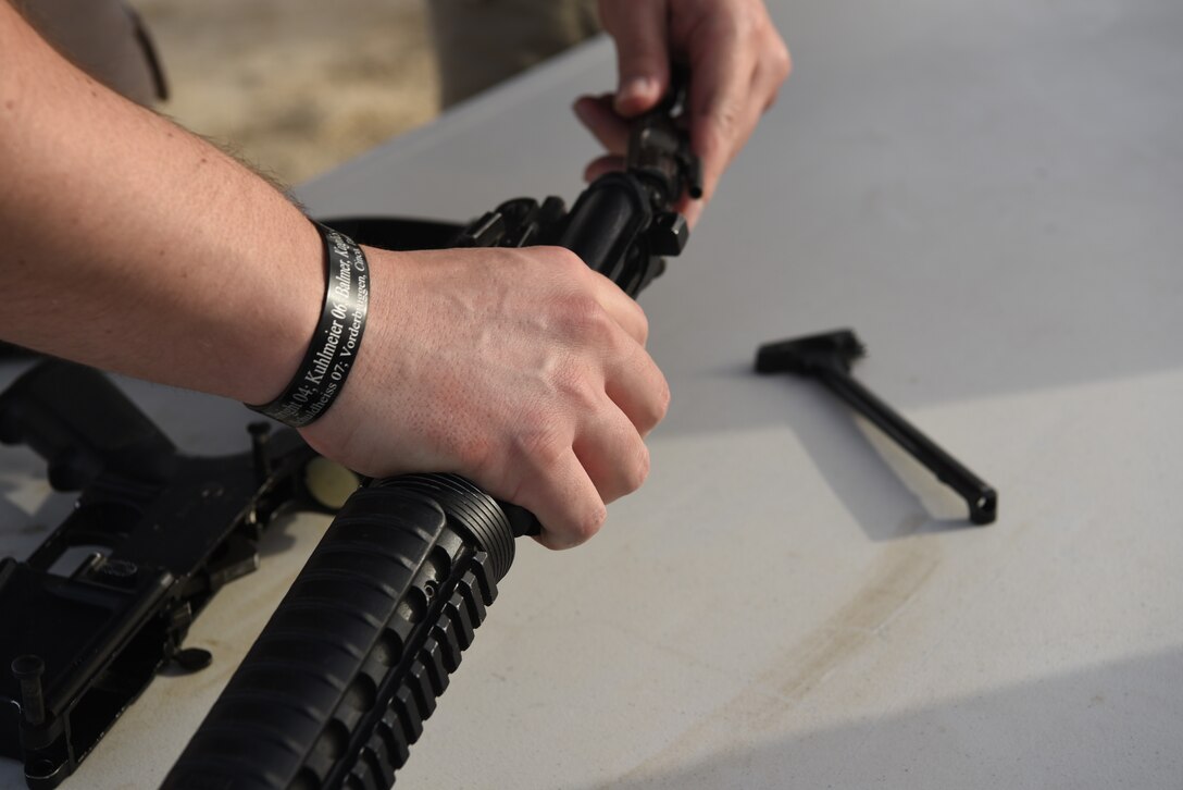 An Airman disassembles a rifle on Al Dhafra Air Base, United Arab Emirates, May 12, 2019.