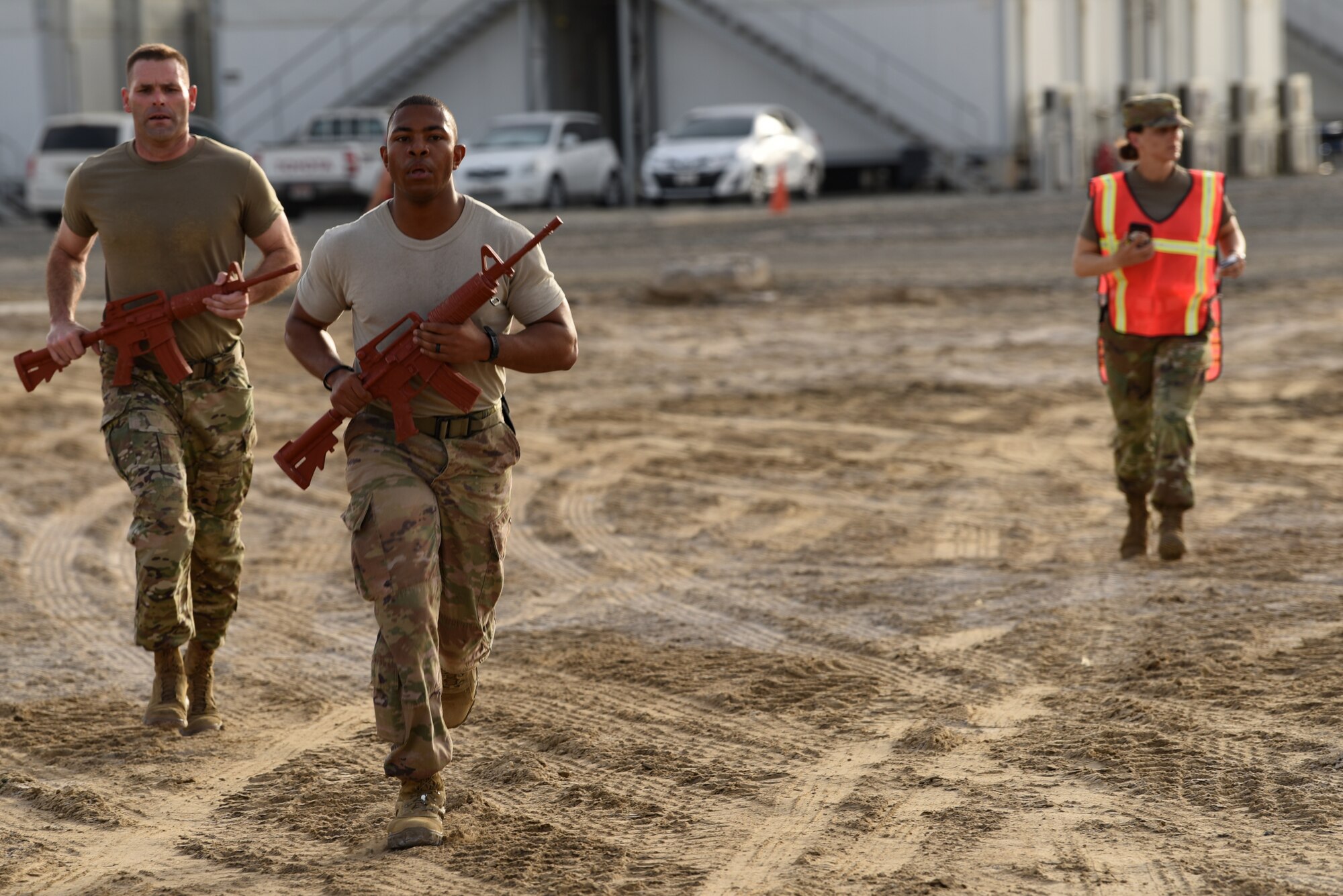 A security forces fire team run their last lap around the Police Week 2019 fire team challenge course May 12, 2019, at Al Dhafra Air Base, United Arab Emirates.