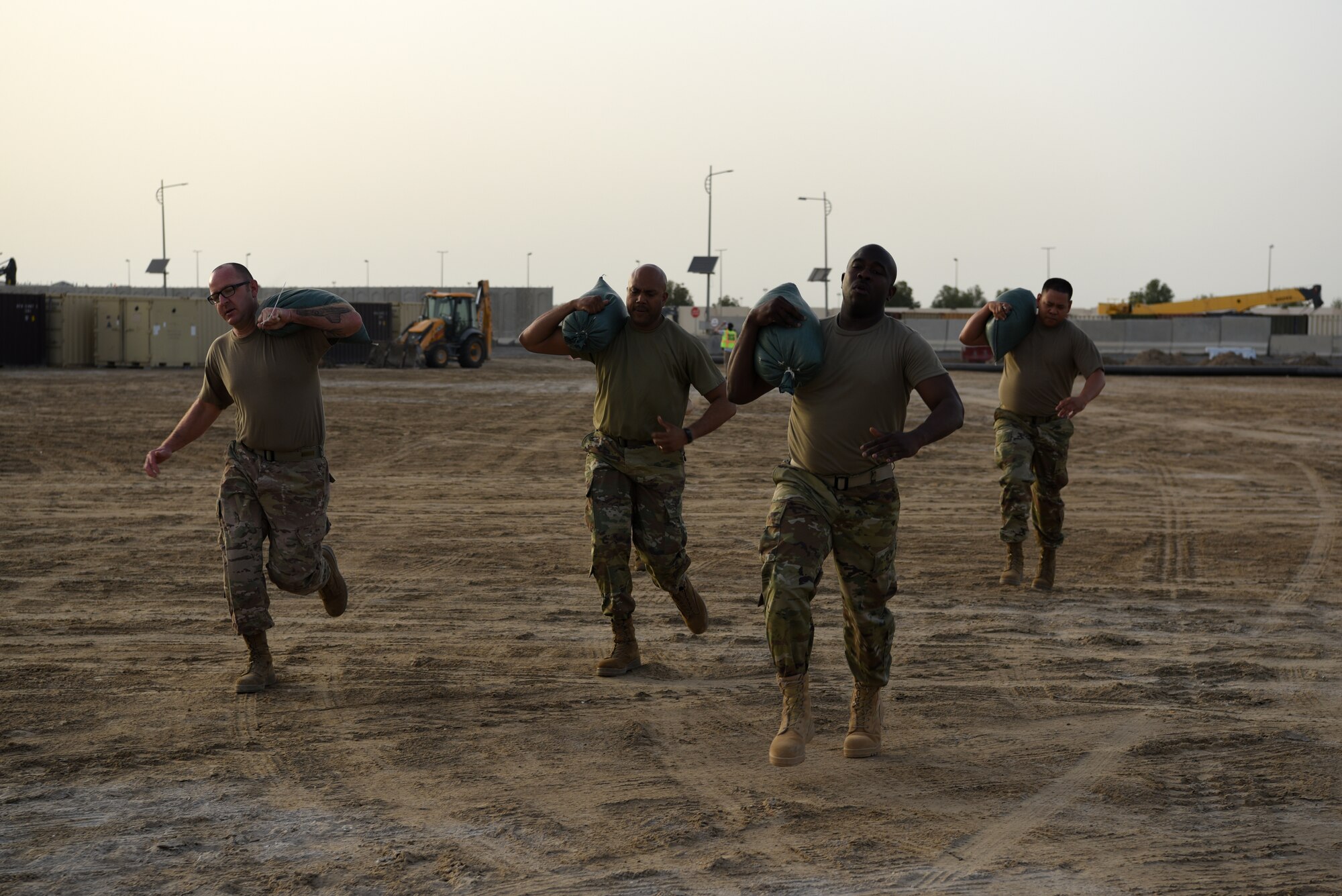 A force protection escort fire team runs with sandbags as part of the Police Week 2019 fire team challenge May 12, 2019, at Al Dhafra Air Base, United Arab Emirates.