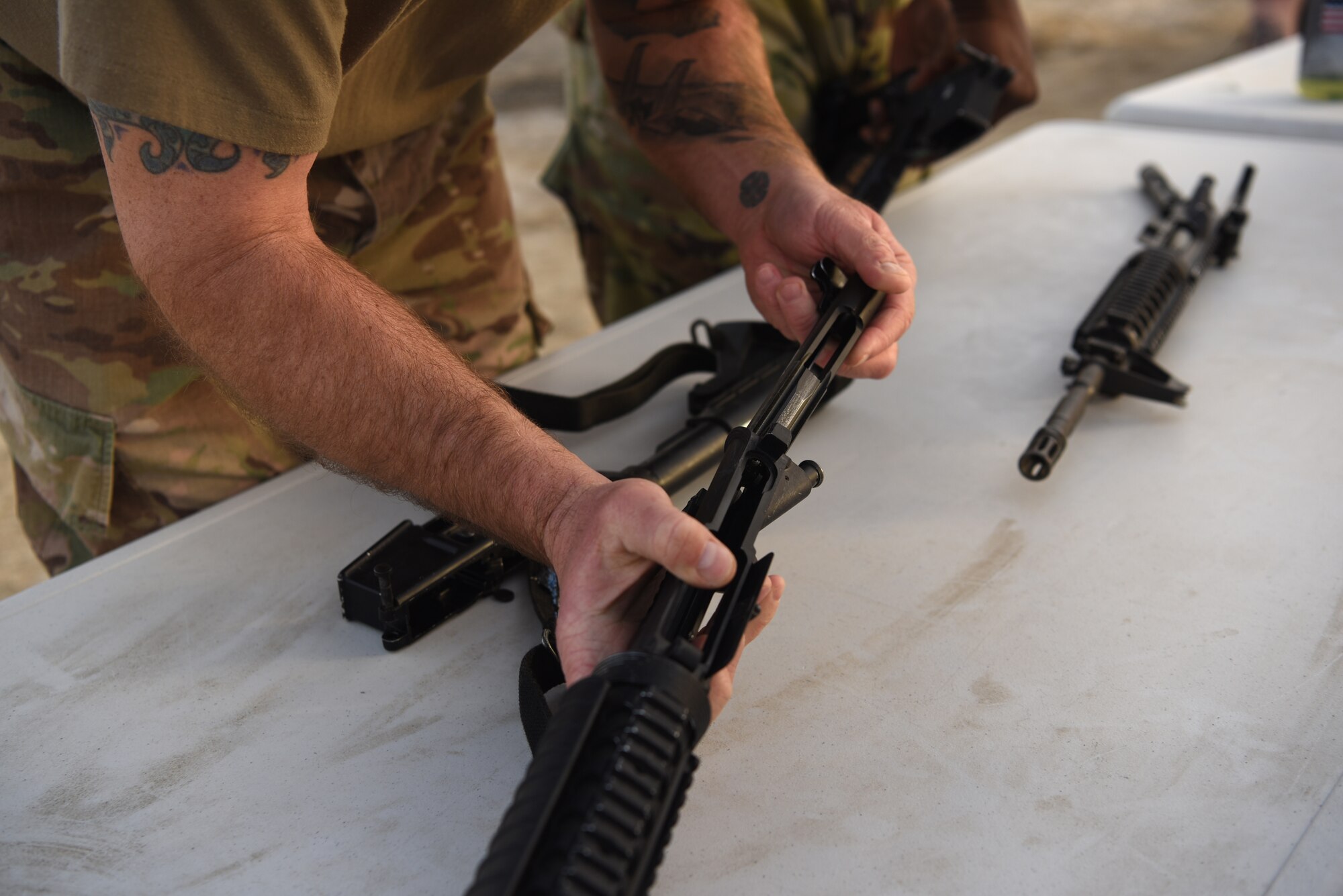 An Airman disassembles a rifle on Al Dhafra Air Base, United Arab Emirates, May 12, 2019.