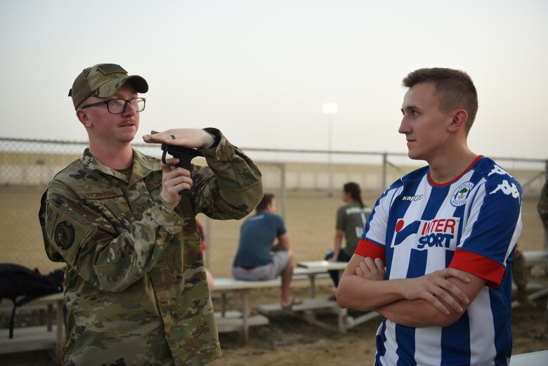 A combat arms instructor answers questions about the Mine Resistant Ambush Protected vehicle displayed during Police Week 2019, May 13, 2019, at Al Dhafra Air Base, United Arab Emirates.