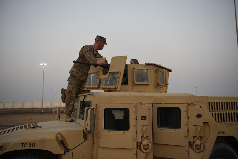 Master Sgt. Sean Fetke, 380th Expeditionary Security Forces training section chief, answers questions about the Humvee and mounted .50 caliber machine gun displayed during Police Week 2019, May 13, 2019, at Al Dhafra Air Base, United Arab Emirates.
