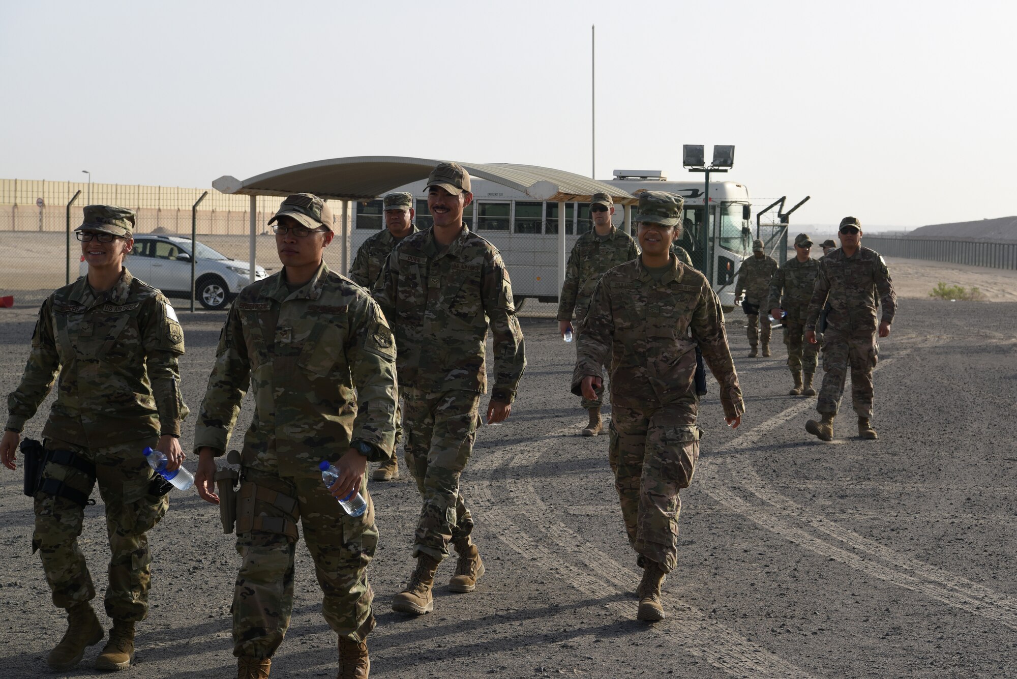 Airmen of the 380th Air Expeditionary Wing offload a bus onto a firing range to participate in a pistol competition during Police Week 2019, May 13, 2019, at Al Dhafra Air Base, United Arab Emirates.