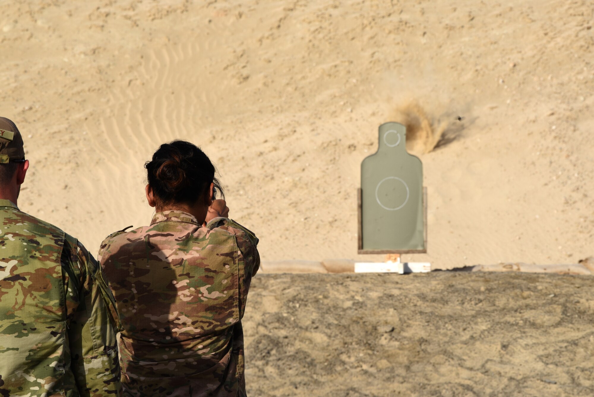 A member of the 380th Air Expeditionary Wing fires at a target during a pistol competition for Police Week 2019, May 13, 2019, at Al Dhafra Air Base, United Arab Emirates.