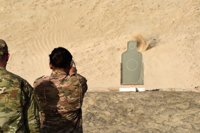 A member of the 380th Air Expeditionary Wing fires at a target during a pistol competition for Police Week 2019, May 13, 2019, at Al Dhafra Air Base, United Arab Emirates.