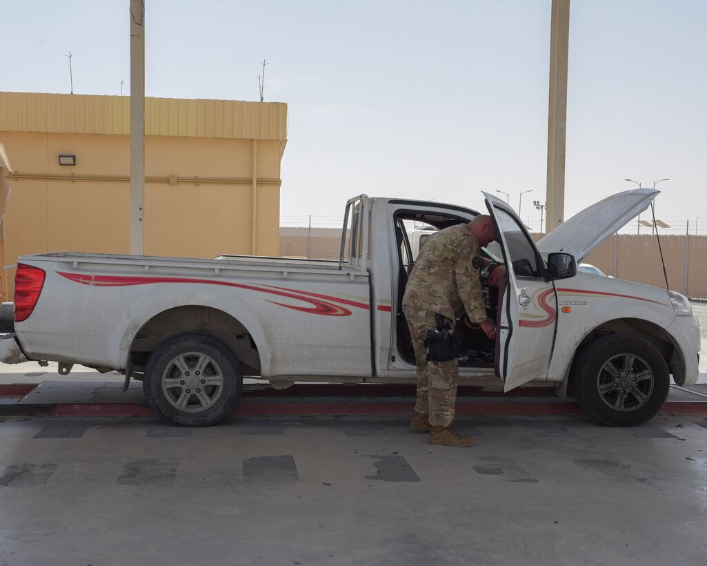 Tech. Sgt. Daniel Becker, 380th Expeditionary Security Forces Squadron defender, brings a car to a halt before inspection May 14, 2019, at Al Dhafra Air Base, United Arab Emirates. Other Country Nationals and their vehicles must be vetted before arriving to the American compounds to ensure the security and safety of the installation. (U.S. Air Force photo by Staff Sgt. Chris Thornbury)
