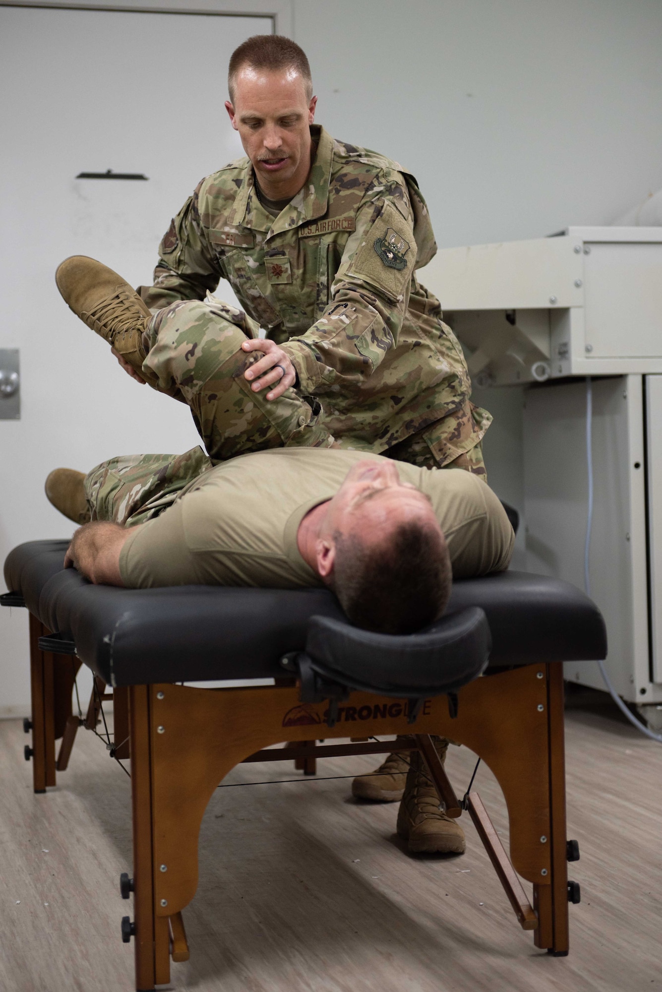 Maj. Adam Frost, 380th Expeditionary Medical Group physical therapist, uses joint manipulation on a patient at the beginning of a treatment May 17, 2019 at Al Dhafra Air Base, United Arab Emirates.     
Fry involves dry needling, a form of acupuncture, and cupping into his treatments – he has found both to be extremely effective at targeting trigger points, releasing muscle spasms and alleviating pain. (U.S. Air Force photo by Staff Sgt. Chris Thornbury)