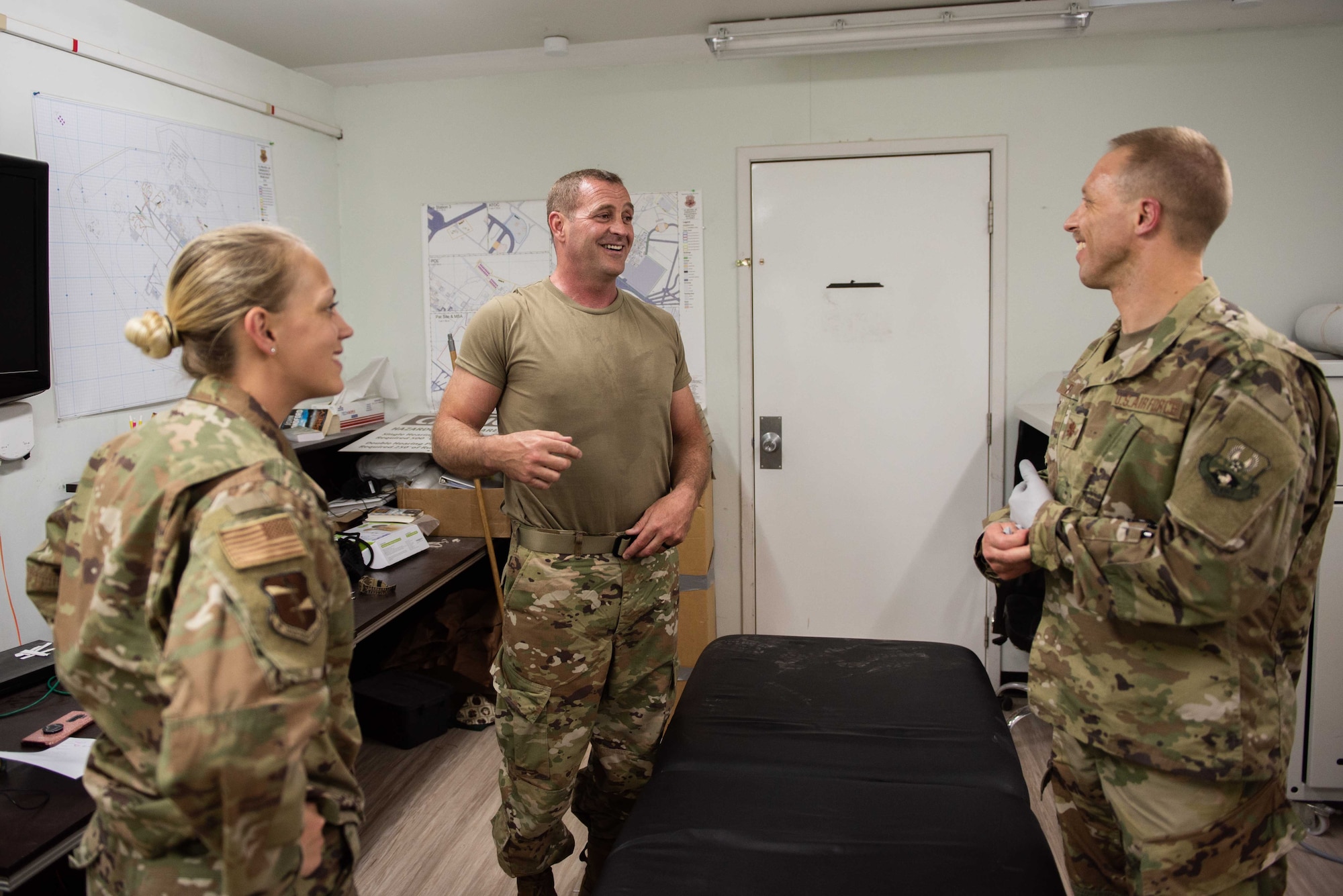 The 380th Expeditionary Medical Group physical therapist team talk to a patient after a treatment May 17, 2019 at Al Dhafra Air Base, United Arab Emirates. The team of two performs treatments for pain relief and then educates patients in injury prevention. (U.S. Air Force photo by Staff Sgt. Chris Thornbury)