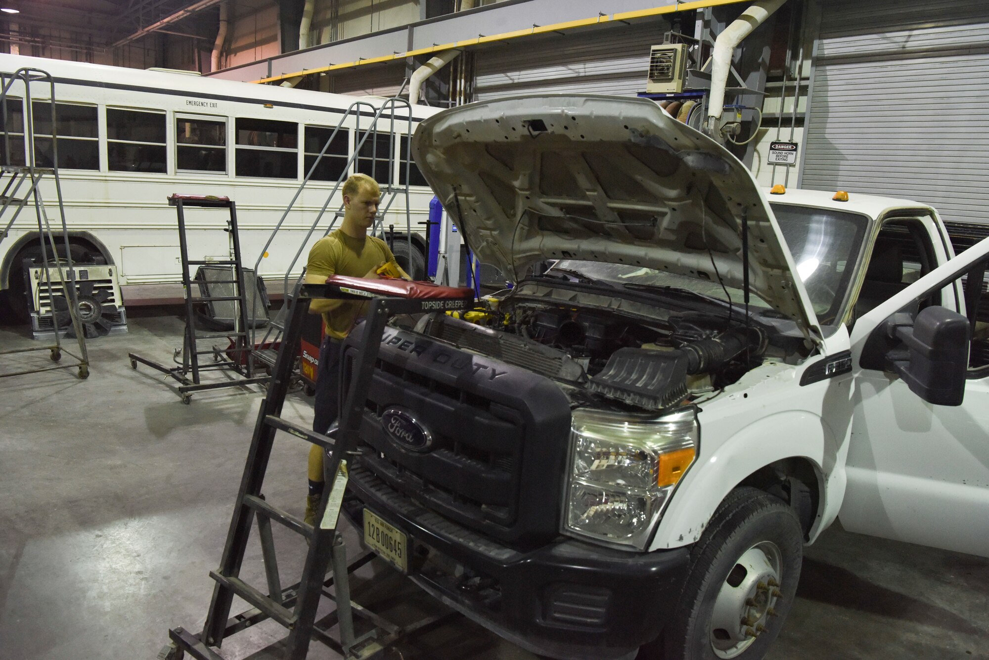 Senior Airman Steven Staley, 379th Expeditionary Logistics Readiness Squadron mission generation vehicular equipment maintenance journeyman, performs maintenance on a vehicle at Al Udeid AB, Qatar, on May 22, 2019. The 379th LRS is responsible for maintaining all the vehicles for team AUAB. (U.S. Air Force photo by Staff Sgt. Ashley L. Gardner)