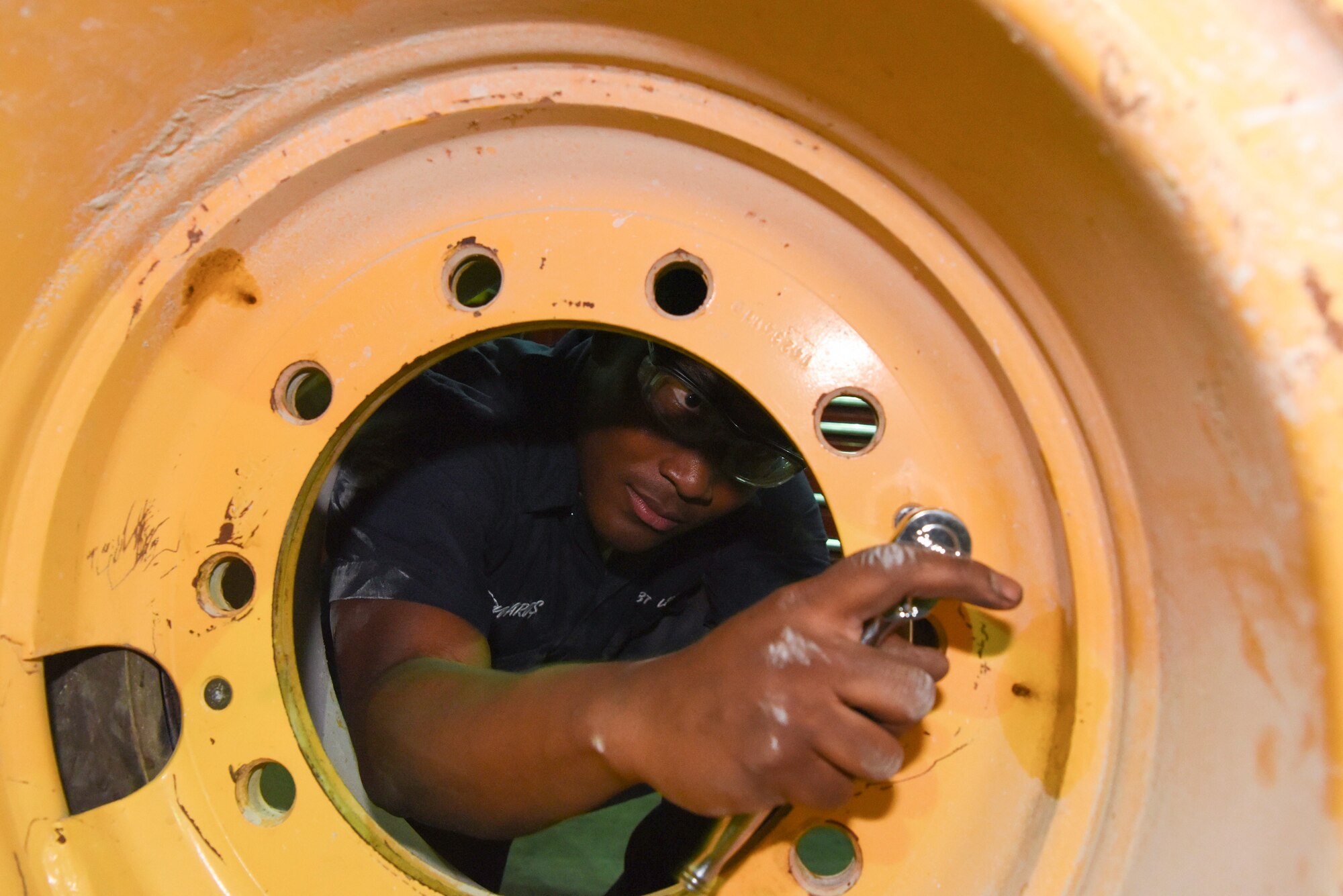 Airman 1st Class Jordan Edwards, 379th Expeditionary Logistics Readiness Squadron mission generation vehicular equipment maintenance journeyman, disassembles a tire at Al Udeid AB, Qatar, on May 22, 2019. The 379th LRS has the largest vehicle fleet in the Air Force Central Command, with over 2,500 government owned and leased vehicles.  (U.S. Air Force photo by Staff Sgt. Ashley L. Gardner)