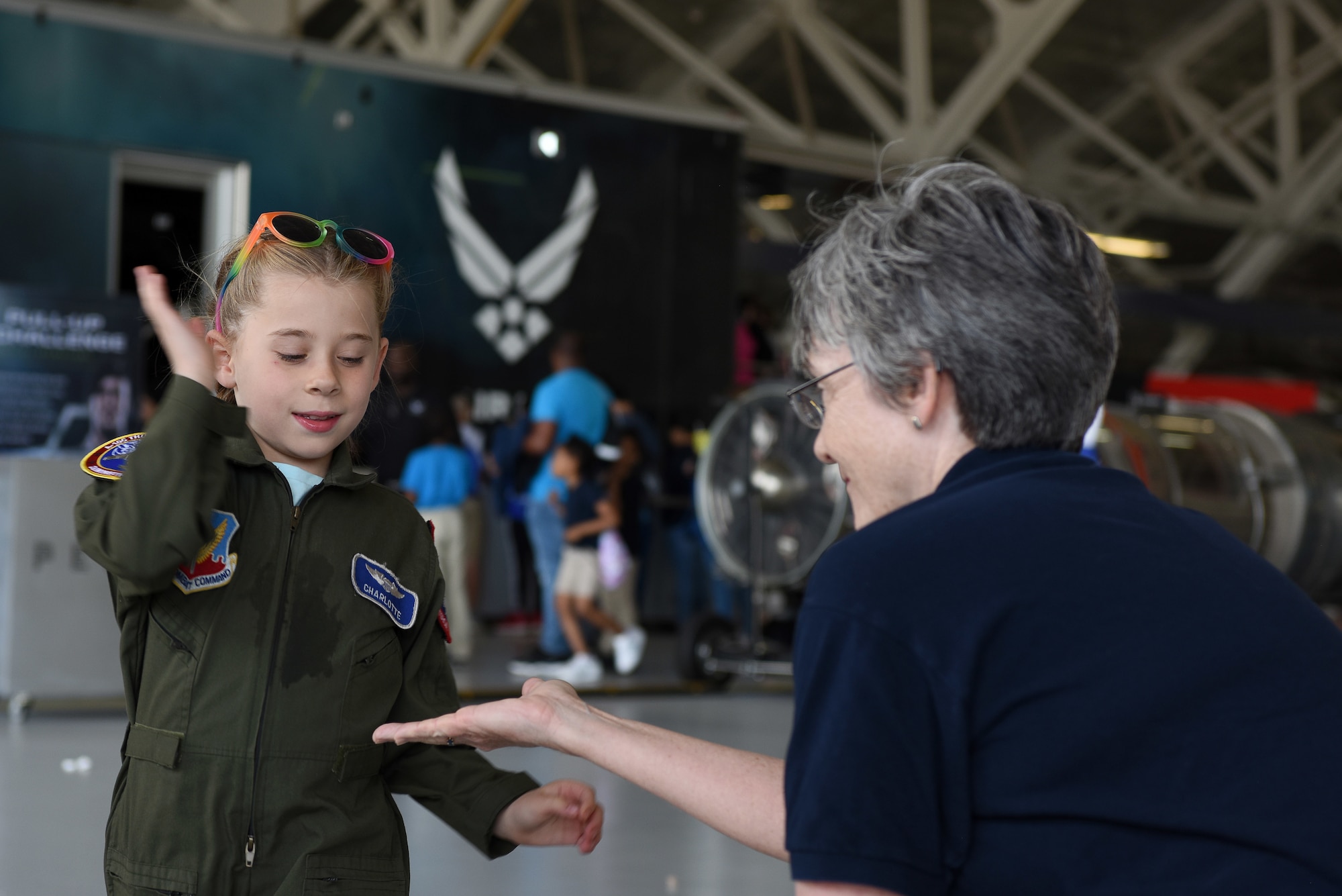 Secretary of the Air Force Heather Wilson receives a high-five from a child