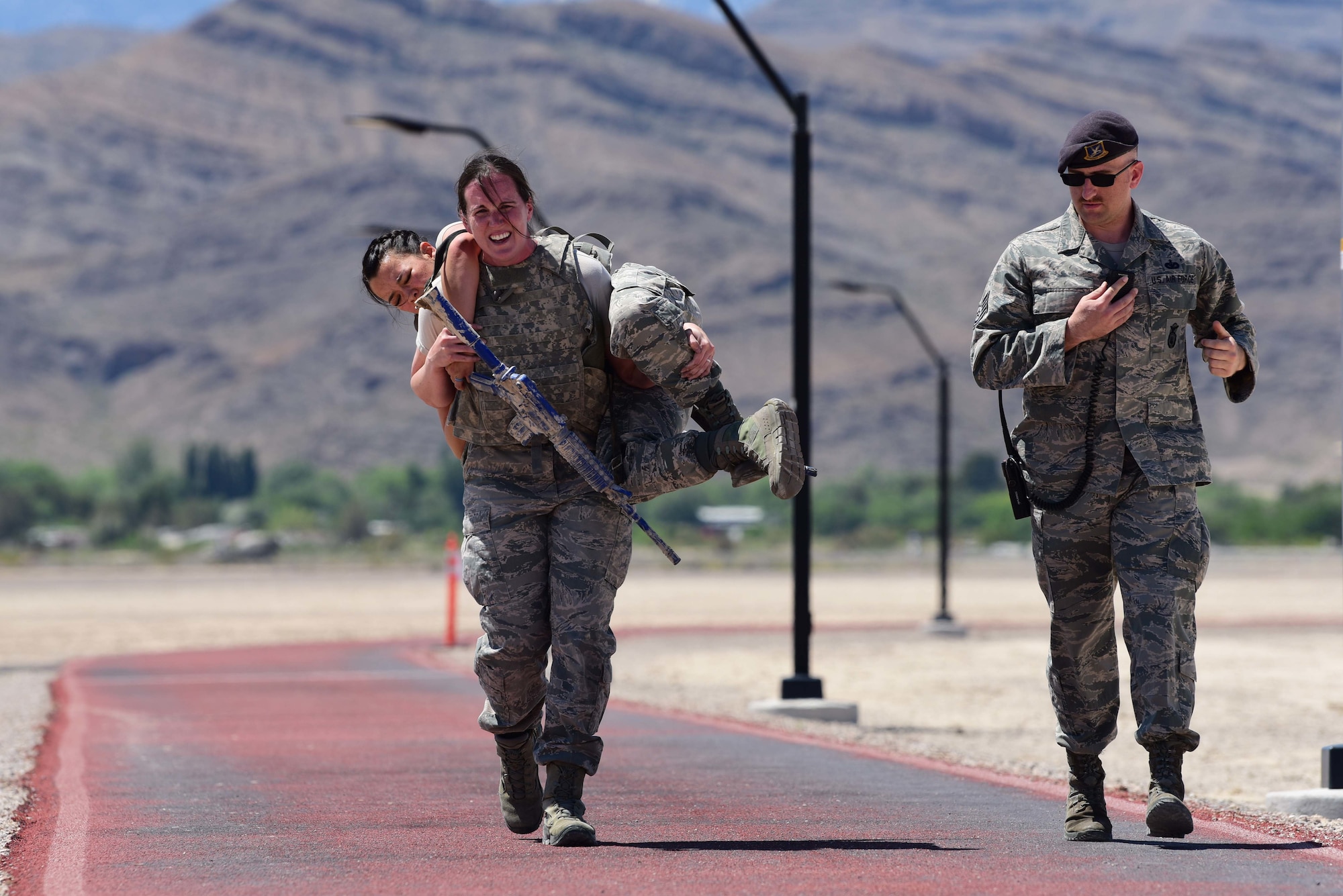 Capt. Sarah, 799th Air Base Squadron Force Support Flight chief, carries 1st Lt. Ryann, 799th ABS Military Personnel Flight commander, during a police week defender challenge