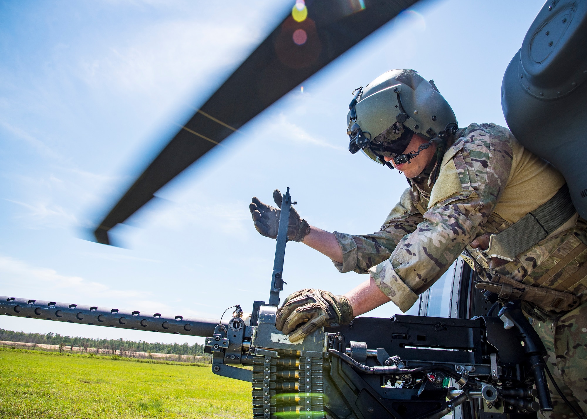 An Aviator inspects an M2 machine gun