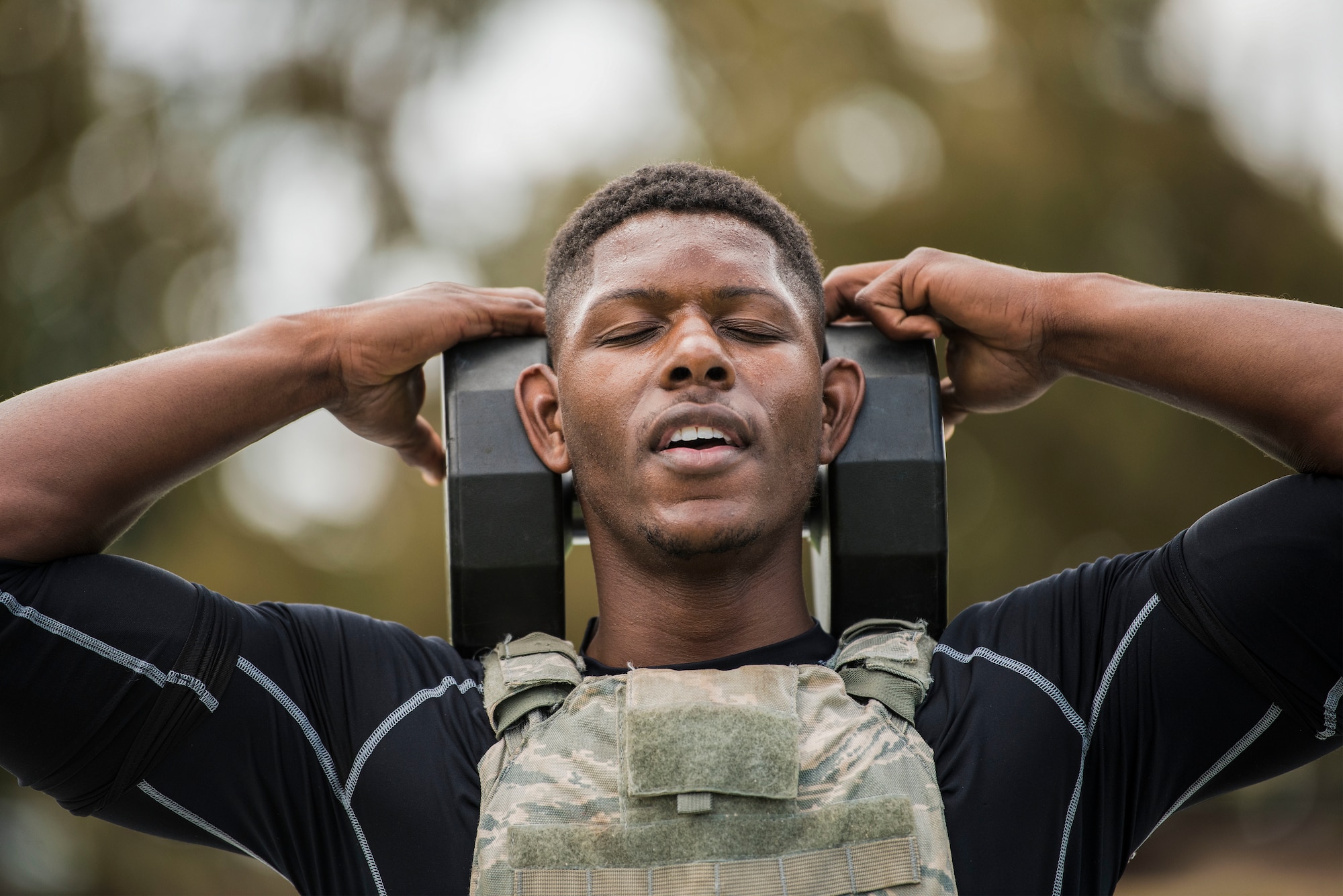 First Lt. Xavier Jones, 17th Training Squadron test team project manager, performs box steps with a 50 pound weight during the police week warrior workou
