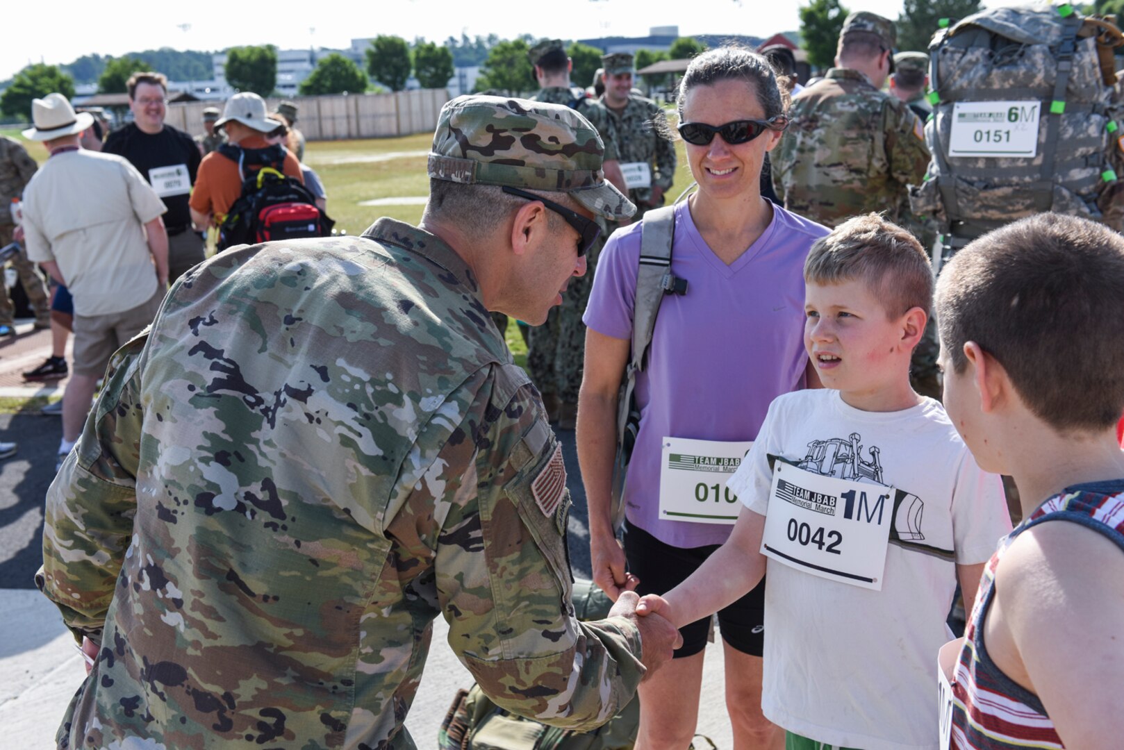 Chief Master Sgt. Benjamin “Jake” Higginbotham thanks Jenna Ettlich and her sons for being part of the 2019 Team JBAB Memorial March, on Joint Base Anacostia-Bolling, Washington, D.C., May 23.